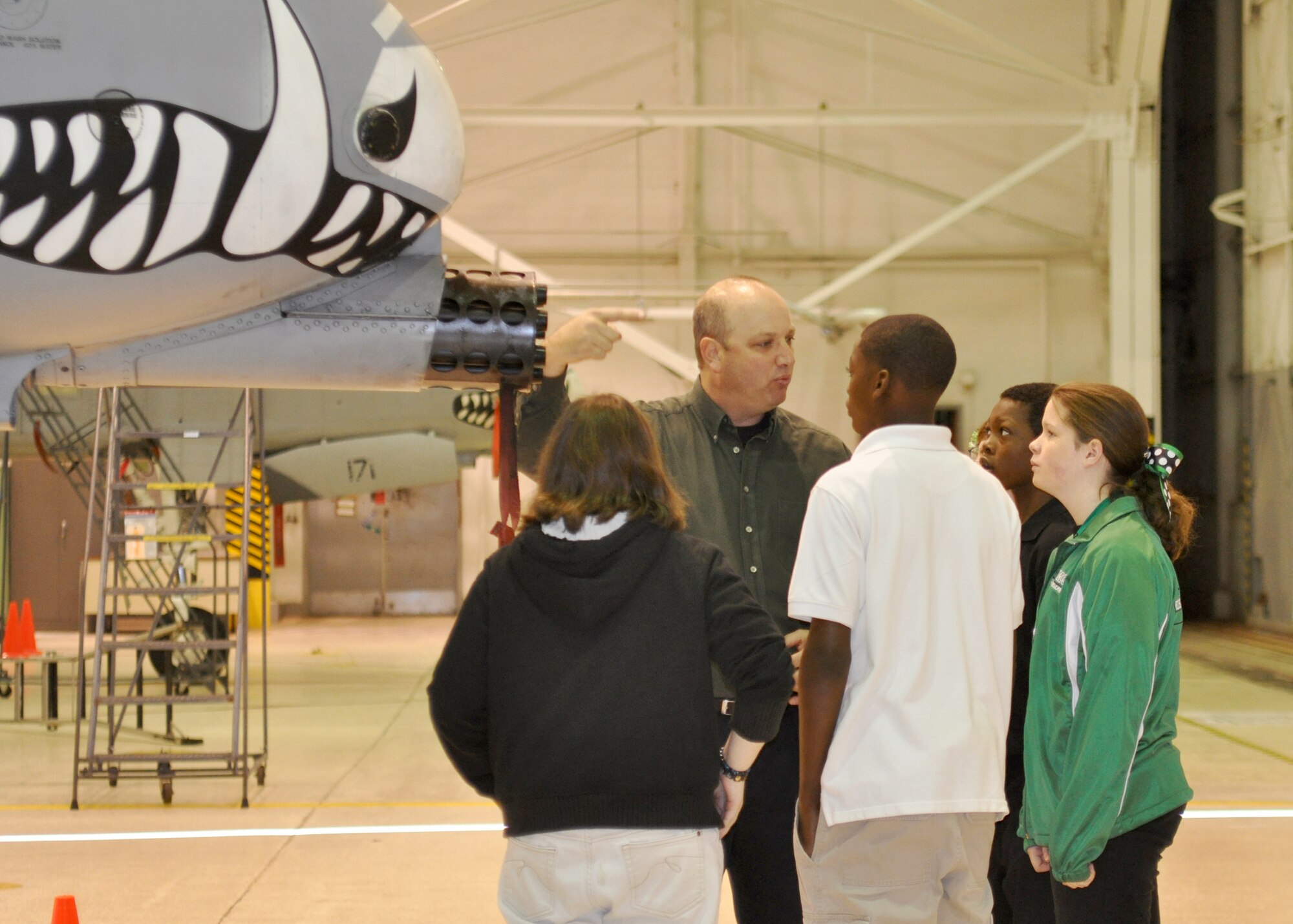 Brett Barow, a flight simulator instructor for the Bossier Parish area, explains how the weapons systems on an A-10 Thunderbolt II work to his aerospace students during a base tour of the 917th Wing on Barksdale Air Force Base, La. December 21, 2009. Barrow, a former Master Sergeant with the United States Air Force, retired out of Barksdale after 20 years of service.  Barrow returned Barksdale with 32 of his students who attained the highest grade point averages from the aerospace course at Rusheon Middle School located in Bossier City, La. (U.S. Air Force Photo/ Senior Airman Crystal Marie Jordan)