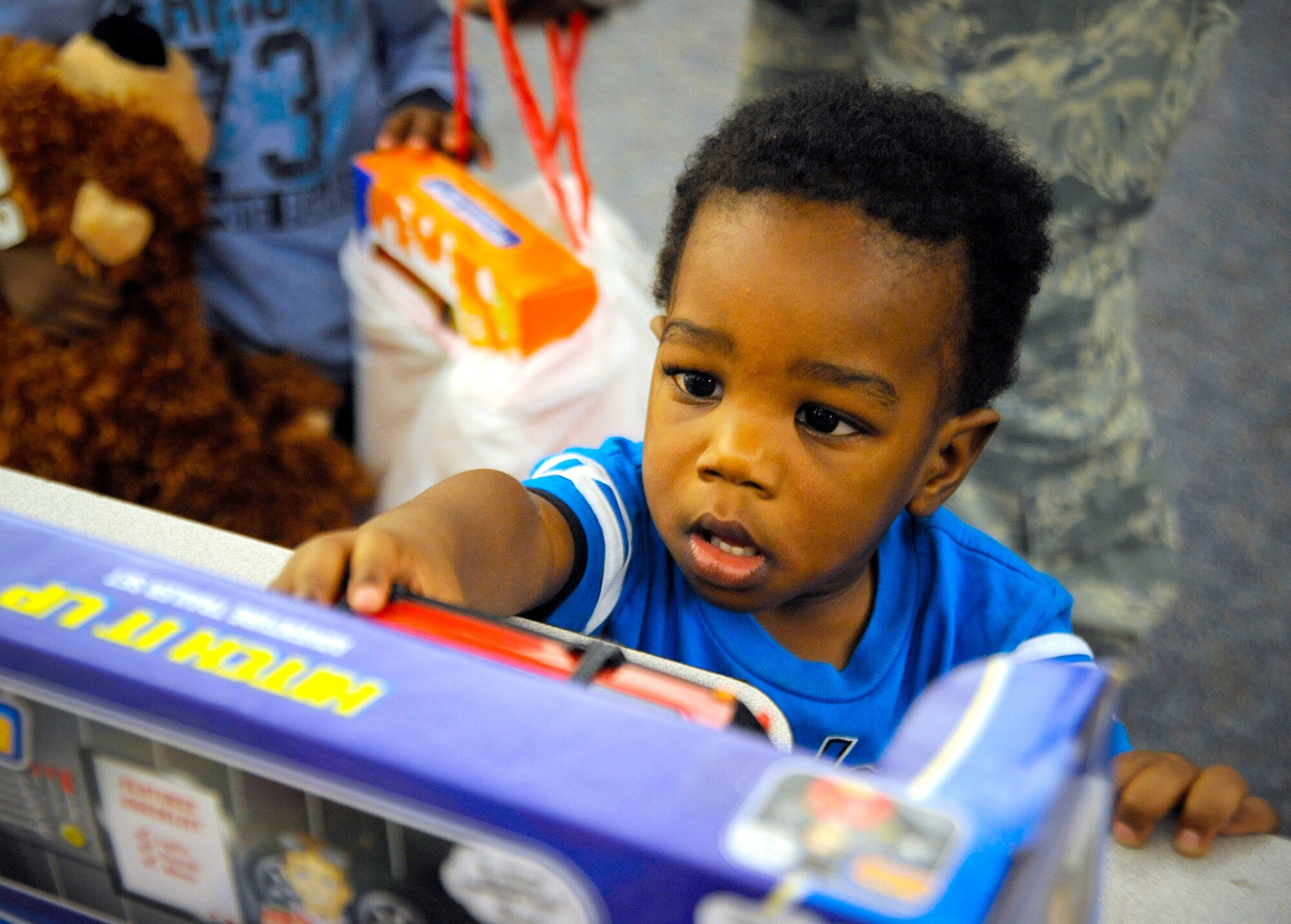 Christian Williams, 1, Son of Staff Sgt. Christina Williams, 6th Security Forces Squadron, picks out his toy at a Christmas party. Ex-POW’s and Rolling Thunder teamed up to donate more than 300 toys and $5,000 in cash to military families for Christmas. The event was sponsored on base by the Airman & Family Readiness Center. (U.S. Air Force photo by Staff Sgt. Joseph L. Swafford Jr.)
