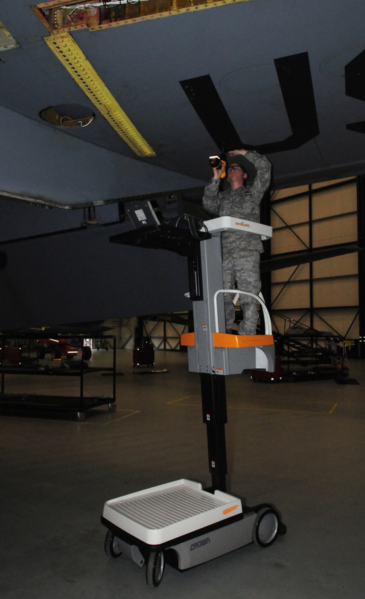 Staff Sgt. Christopher Klaus, 100th Maintenance Squadron ISO dock controller, uses a new mobile maintenance stand, purchased as part of an Air Force Smart Operations for the 21st Century project, to install the lower aileron lockout access panel on the left wing of a KC-135 Stratotanker Dec. 9, 2009. December 9 was a repanel day, when 11 ISO dock members took part in installing 250 panels, prior to the aircraft removal from the hangar for engine runs. The mobile stands, used in-place of the old wing stands, cost the Air Force about $100,000 for seven stands. The stands have already saved more than 600 man-hours and hundreds of thousands of dollars. (U.S. Air Force photo/Karen Abeyasekere)