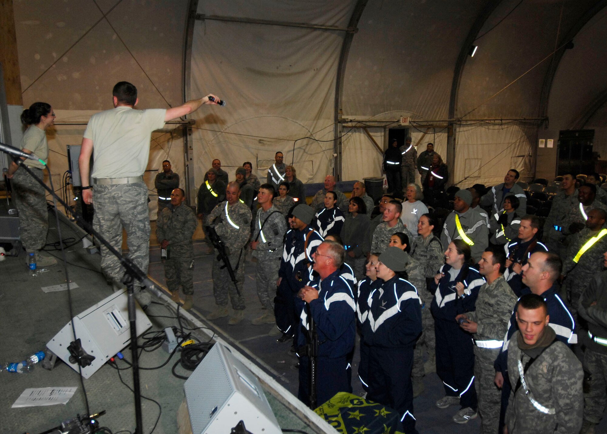 BAGRAM AIRFIELD, Afghanistan -- Sirocco lets the audience members sing parts of "Hey Jude" Dec. 23, 2009.  The AFCENT Band travels to different deployed locations to boost the morale of Servicemembers.  The members of the band are deployed from Lackland Air Force Base, Texas.  (U.S. Air Force photo/Senior Airman Felicia Juenke)