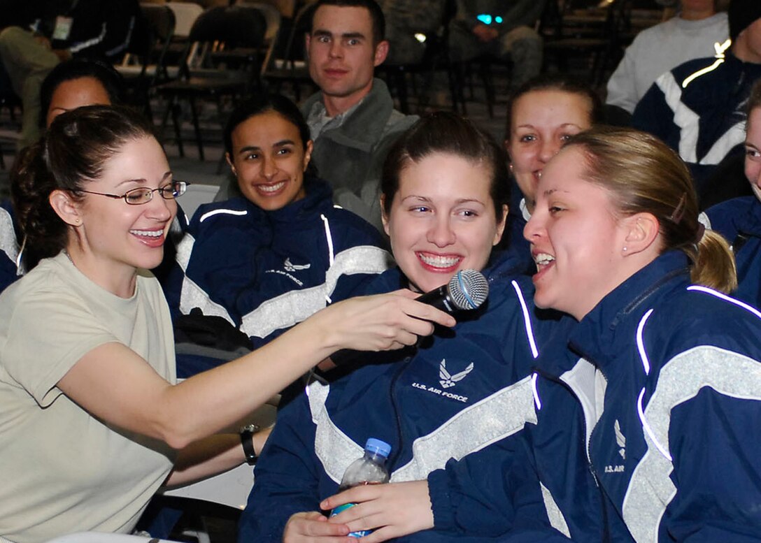 BAGRAM AIRFIELD, Afghanistan -- Tech. Sgt. Christin Foley, a vocalist from Sirocco, lets the audience members sing parts of "Strawberry Wine" Dec. 23, 2009.  The AFCENT Band travels to different deployed locations to boost the morale of Servicemembers.  Sergeant Foley is deployed from Lackland Air Force Base, Texas and hails from Cleveland, Ohio.  (U.S. Air Force photo/Senior Airman Felicia Juenke)