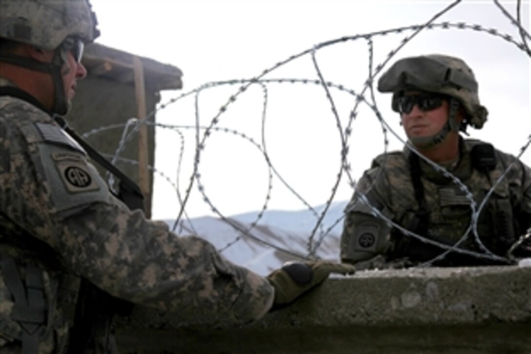 U.S. Army 1st Lt. Erik Beundia, left, and Staff Sgt. Jack Crites, right, discuss security during a mission, Dec. 18, 2009, Parwan, Afghanistan. Both are assigned to the 82nd Division's Company B, Special Troops Battalion.