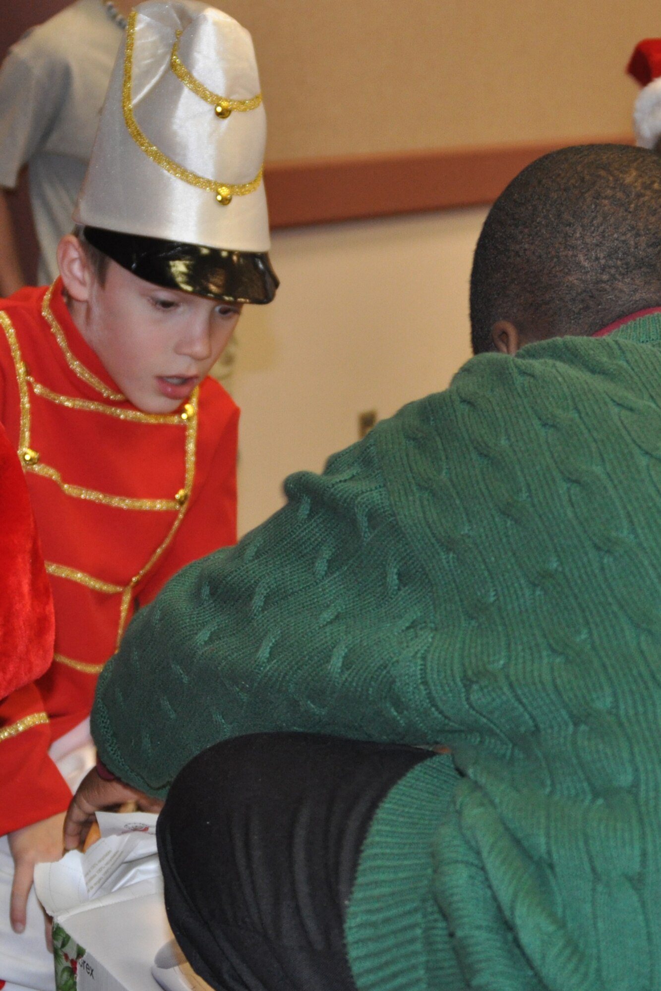 Clayton Wood, son of Master Sgt. Rachell Wood, the Santas in Blues point of contact for the 917th Wing on Barksdale Air Force Base, La., gasps in surprise as he watches the unwrapping of a gift by a foster child during the Santas in Blues children’s party at the Bossier City Civic Center December 19, 2009. Santas in Blues is a base-sponsored program which allows Airmen to sponsor underprivileged foster children in the Caddo, Bossier, Webster and De Soto parishes by providing gifts during the holiday season. Each foster child at the event received three gifts purchased with donations from numerous units and organizations on Barksdale. (U.S. Air Force Photo/ Senior Airman Crystal Marie Jordan)
