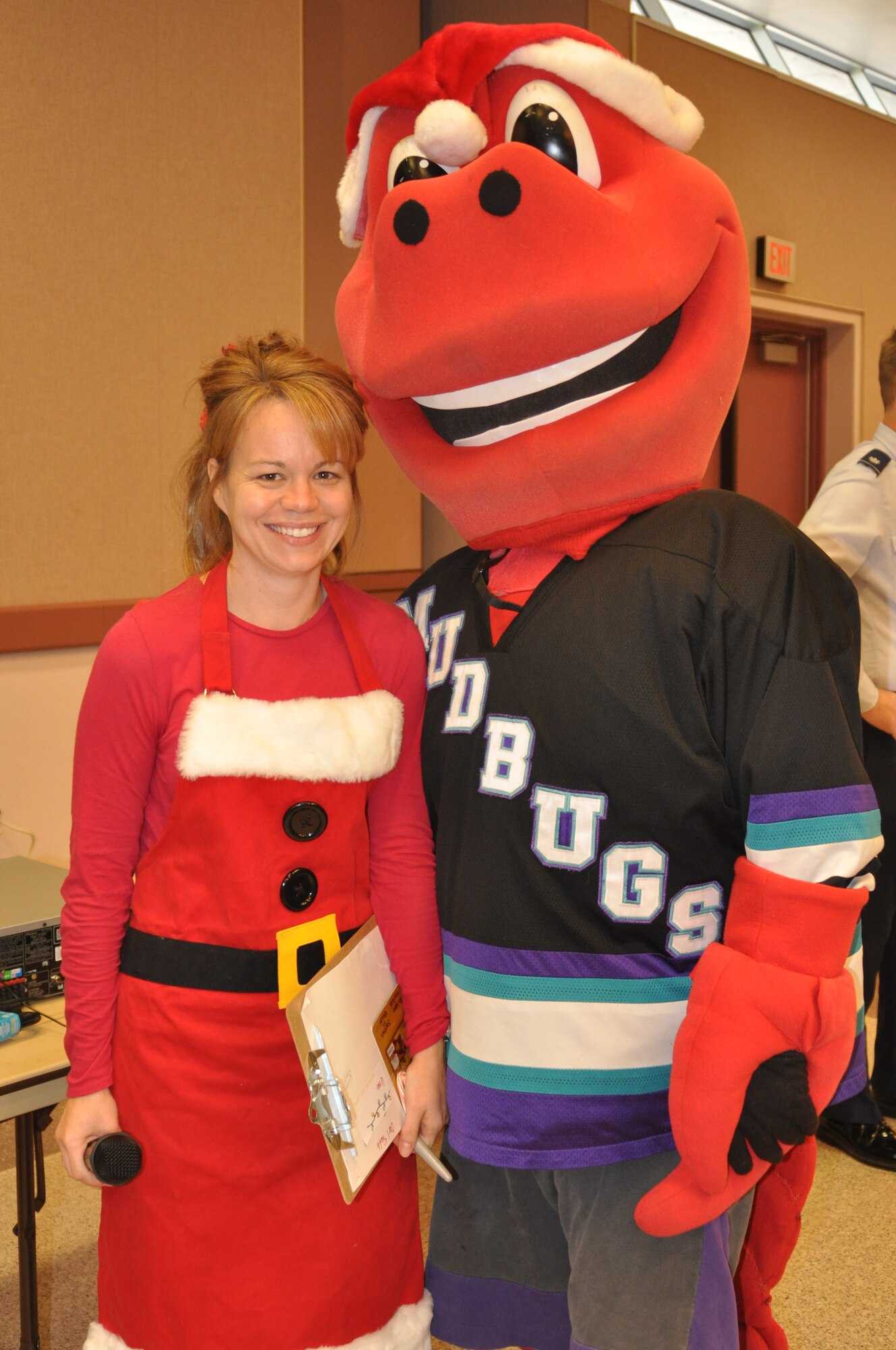 Master Sgt. Rachell Wood, Santas in Blues point of contact for the 917th Wing at Barksdale Air Force Base, La., pauses for a photo with the Bossier-Shreveport Mudbugs Minor League Ice Hockey Team mascot during the Santas in Blues children’s party at the Bossier City Civic Center December 19, 2009. The 917th Wing began the program’s preparation process with a goal of $2,000 and ended up with a whopping $6,243.03, earning bragging rights as the unit which raised the most money this holiday season. (U.S. Air Force Photo/ Senior Airman Crystal Marie Jordan)