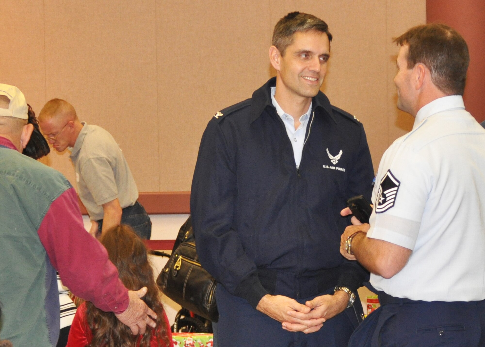 Col. Steven L. Basham, commander, 2nd Bomb Wing at Barksdale Air Force Base, La., speaks with Master Sgt. Jeffery Bryant, the chairman for Santas in Blues on Barksdale at the program’s children’s party at the Bossier City Civic Center December 19, 2009. Santas in Blues is a base-sponsored program which allows Airmen to sponsor underprivileged foster children in the Caddo, Bossier, Webster and De Soto parishes by providing gifts during the holiday season. Airmen helped distribute the gifts in their “blues” uniform at the two parties held for the children. (U.S. Air Force Photo/ Senior Airman Crystal Marie Jordan)
