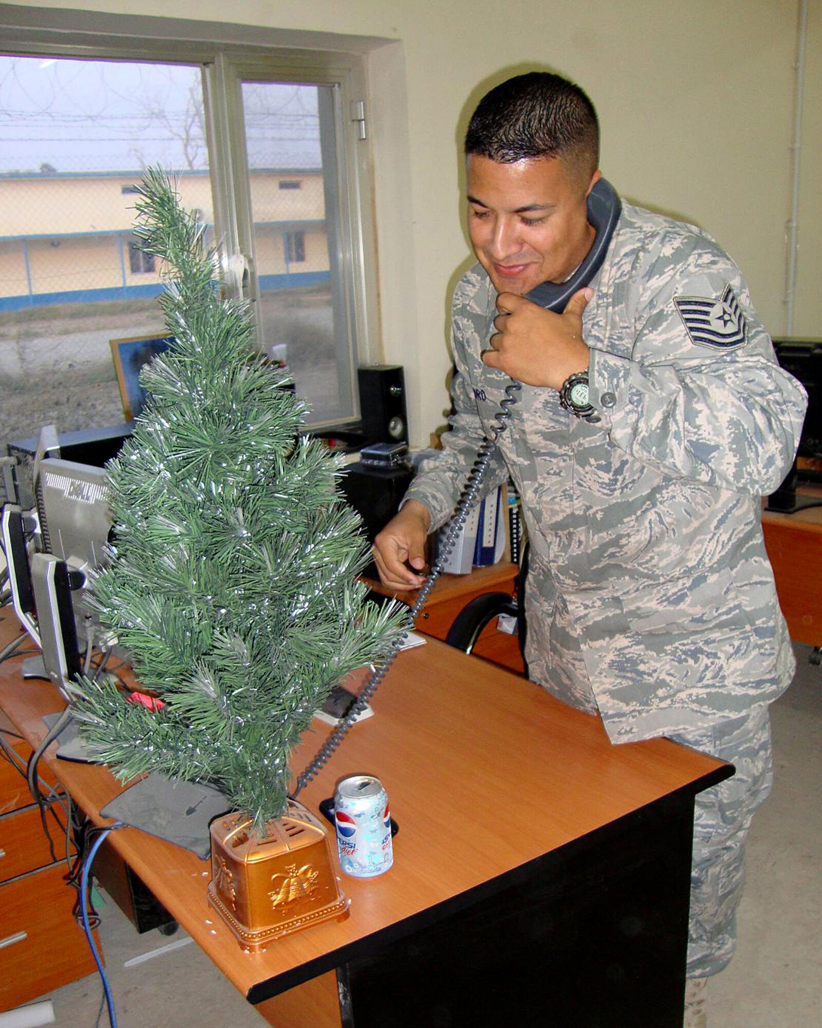 CAMP TAJI, Iraq -- Air Force Tech. Sgt. Donald Pedro, 821st Air Expeditionary Advisory Squadron fuels specialist advisor, chats with President Barack Obama Christmas Eve. The President called to wish him a merry Christmas and thank him for his service.  Sergeant Pedro is deployed from Pope Air Force Base, N.C., and is a native of Pawtucket, R.I.  (U.S. Air Force photo/Capt. Brian Ravak)