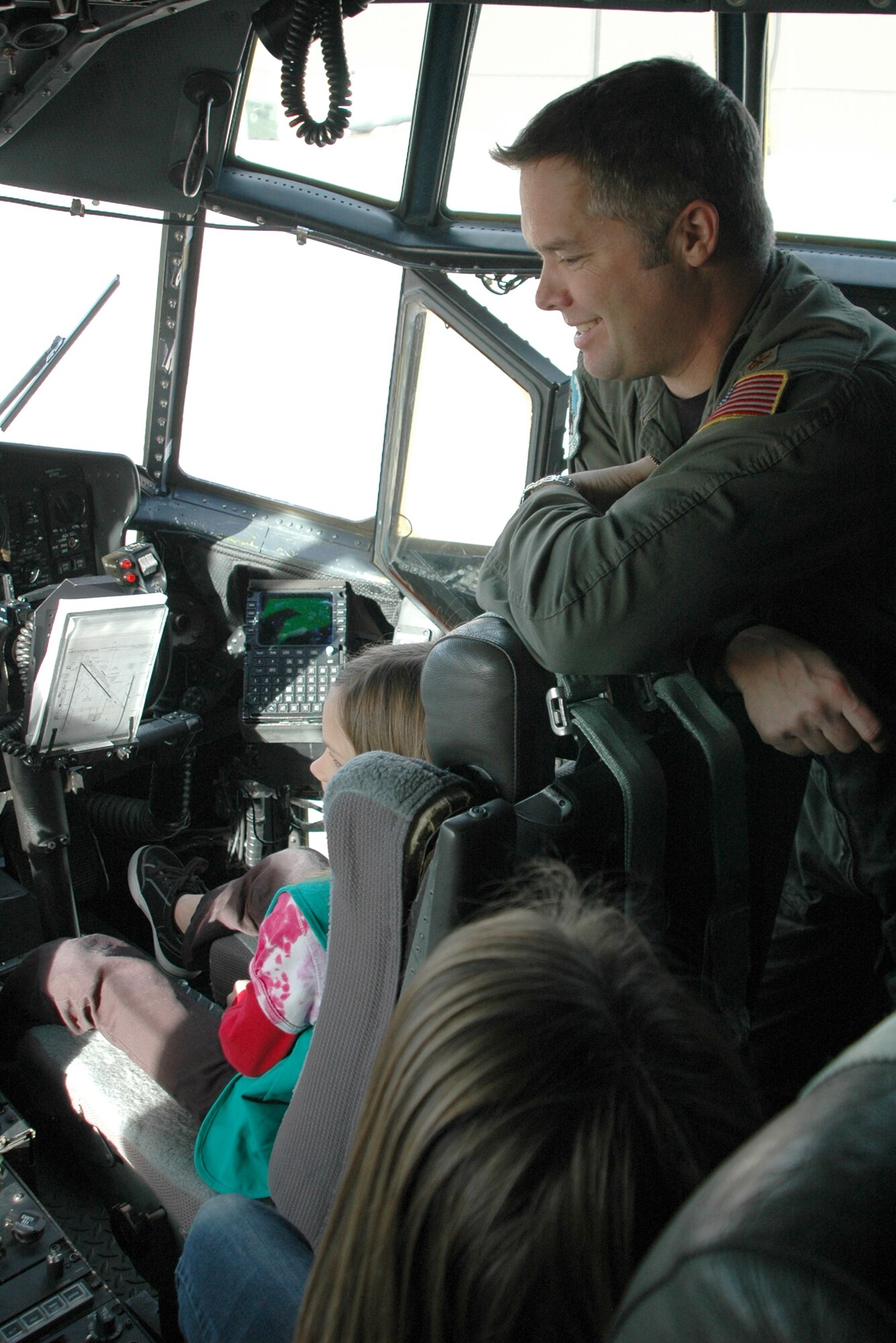 Maj. Brad James, a C-130 pilot assigned to the 731st Airlift Squadron, listens on as girls of Girl Scout Troop 225 ask questions about flying and the Air Force Dec. 21 at Peterson Air Force Base, Colo. The girls, from Woodland Park, Colo., visited the 302nd Airlift Wing where they learned about flying, the C-130 Hercules and the aerial firefighting mission of the wing. The visit allowed the girls to further earn their aeronautical badge. The 302nd Airlift Wing is located in southern Colorado. (U.S. Air Force photo/Staff Sgt. Stephen J. Collier)