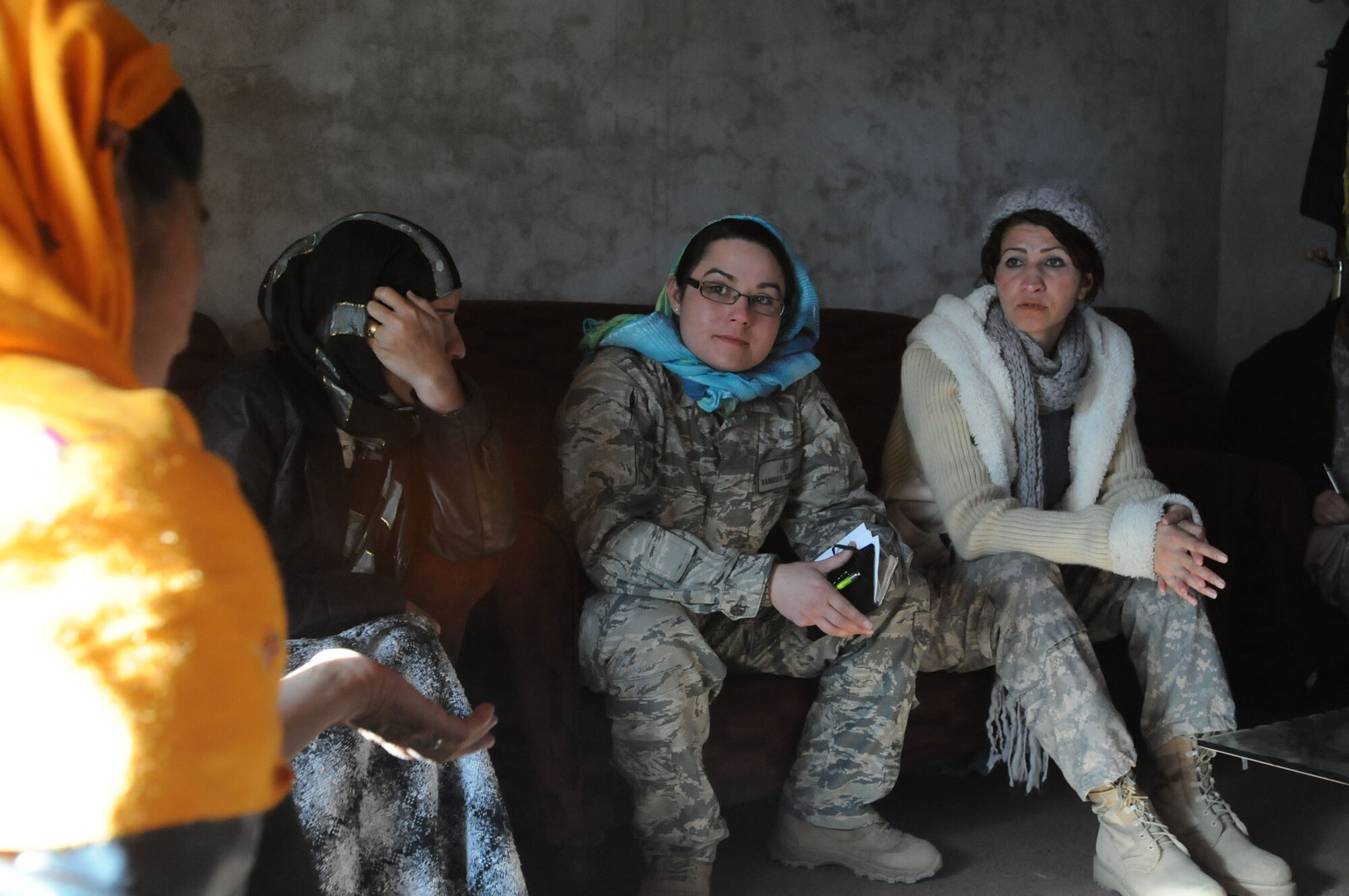 Two members of a Provincial Reconstruction Team at Bagram Airfield, Afghanistan, talk with Mirriam (far left), the director of women's projects in the Panjshir Valley, through an interpreter named Winna (center).  The PRT members had traveled to Forward Operating Base Lion in the Panjshir Valley to meet with Afghan women there.  Female servicemembers deployed to FOB Lion work hand in hand with the local Afghan women, teaching them things like first aid and how to increase their crop output.  (U.S. Air Force photo/Senior Airman Susan Tracy)