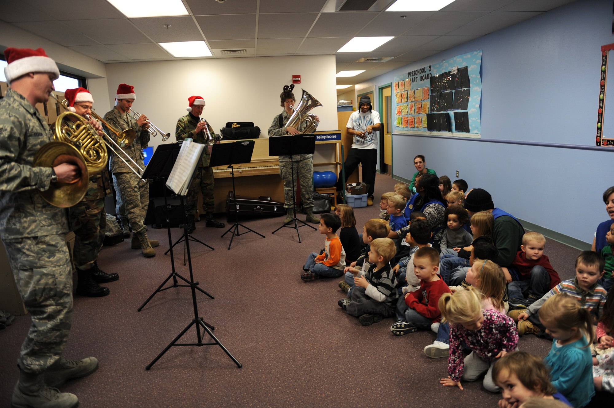 MOUNTAIN HOME AIR FORCE BASE, Idaho -- The Air Force Band of the Golden West brass ensemble plays Christmas carols at the base Child Development Center Dec. 18. The band had a two day visit and played at various locations on base spreading the Christmas joy to all. (U.S. Air Force photo by Airman 1st Class Renishia Richardson)