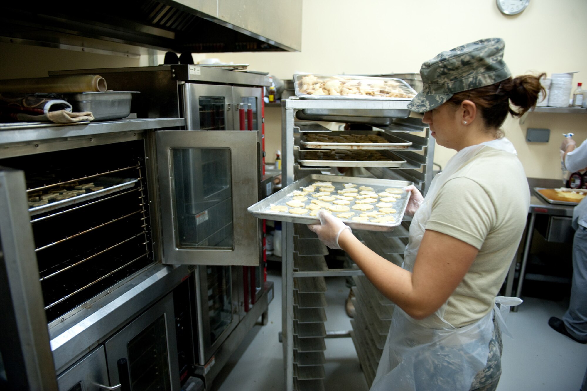 Airman 1st Class Molly Holzem, 379th Force Expeditionary Support Squadron, prepares holiday cookies for servicemembers, Dec. 23, 2009, in Southwest Asia. Airmen Holzem used a family recipe to help those deployed during the holiday season feel more at home. (U.S. Air Force photo/Staff Sgt. Robert Barney)