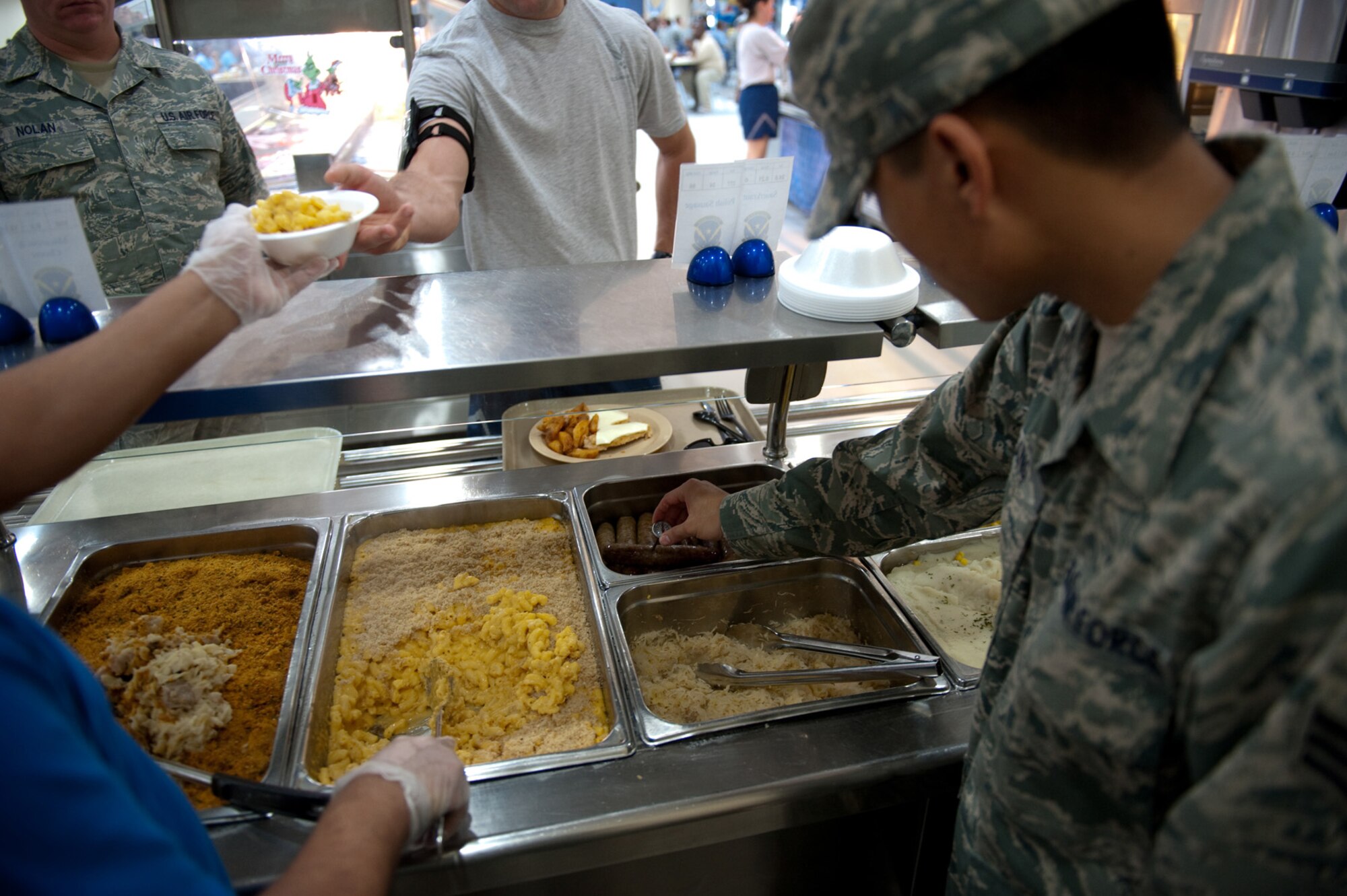 U.S. Air Force Senior Airman Ger Vang, 379th Expeditionary Force Support Squadron, uses a thermometer to ensure food is the correct temperature at a dining facility, Dec. 23, 2009, in Southwest Asia. Airman Vang provides quality assurance control for more than 7,000 meals a day. (U.S. Air Force photo/Staff Sgt. Robert Barney/RELEASED) 