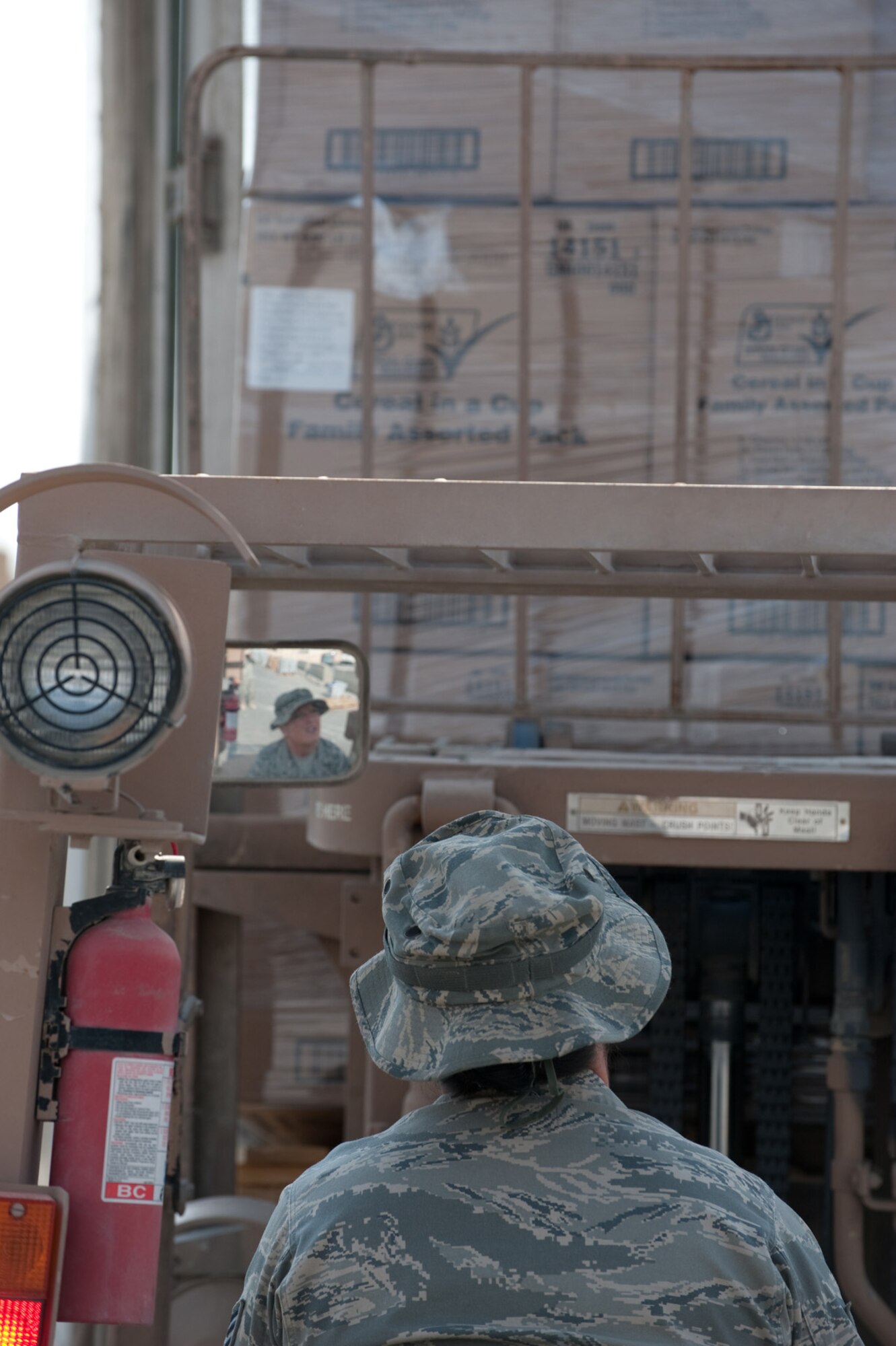 U.S. Air Force Staff Sgt. Cassandra Hampton, 379th Expeditionary Force Support Squadron store room manager, uses a forklift to unload food for a dining facility, Dec. 23, 2009, in Southwest Asia. Sergeant Hampton makes numerous food supply runs a day for this dining facility to help feed the more than 3,500 deployed servicemembers daily. (U.S. Air Force photo/Staff Sgt. Robert Barney/RELEASED) 