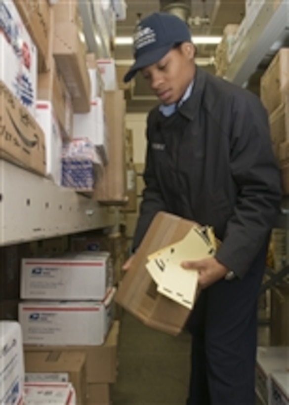 U.S. Navy Seaman Christhea Stroble retrieves packages for customers at the post office at Commander Fleet Activities Yokosuka, Japan, on Dec. 23, 2009.  During the holiday season the post office handles more than 250,000 packages for the residents of the base.  