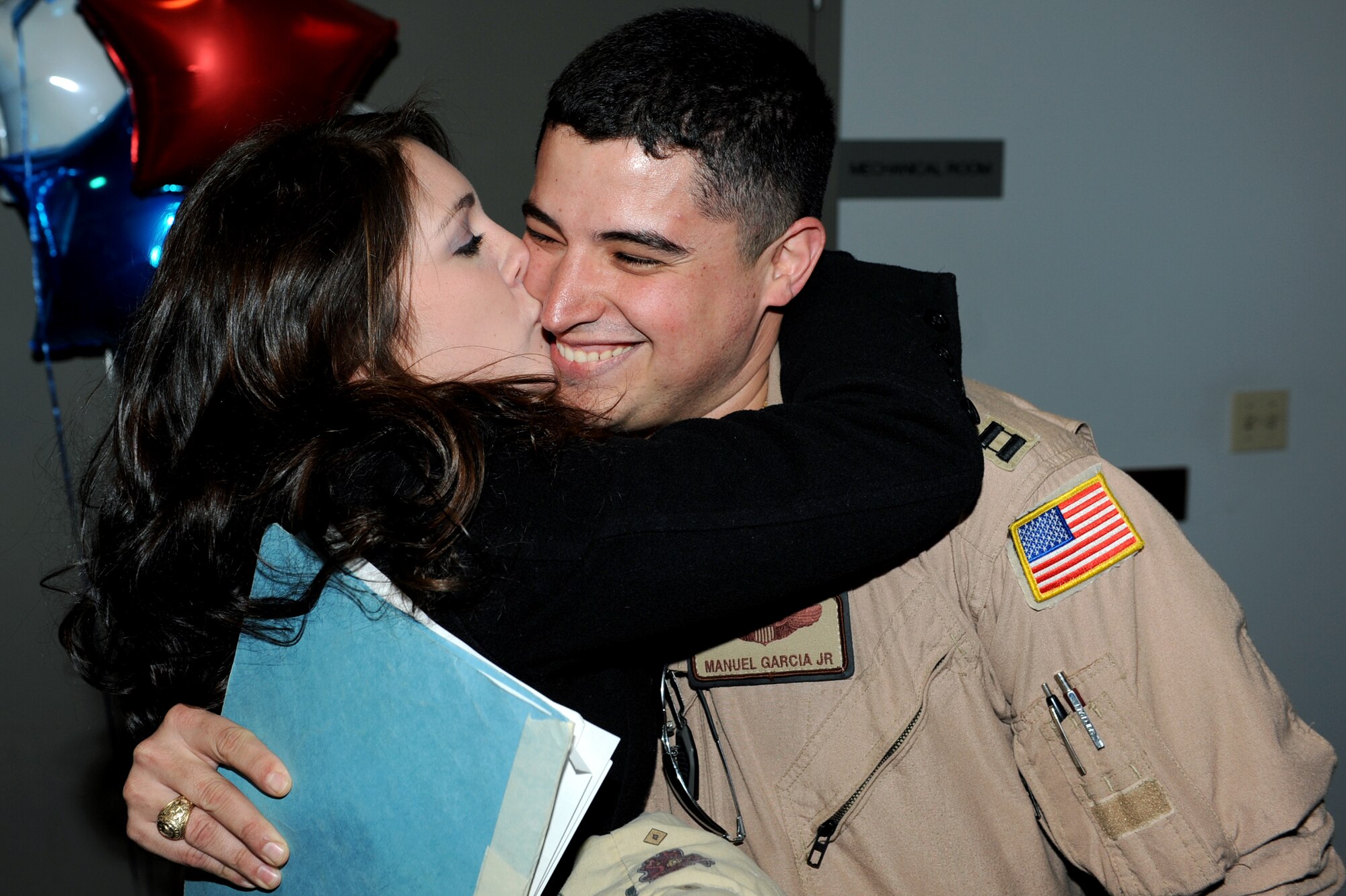 Capt. Manuel Garcia Jr, a 53rd Airlift Squadron pilot, is greeted Christmas Day by his friend, Leslie Mueller. The Airmen returned home Dec. 25 after a four-month deployment to Southwest Asia. Base members, friends and family turned out in force to welcome the Airmen home. (U.S. Air Force photo by Senior Airman Ethan Morgan)