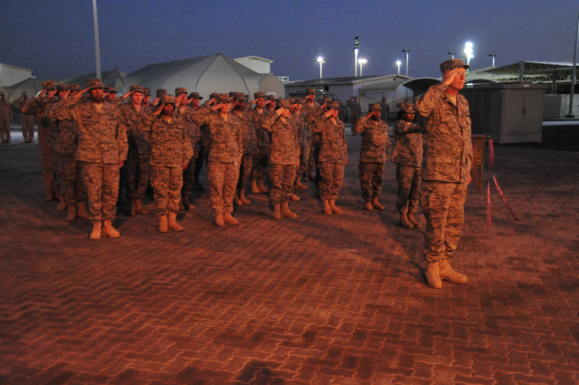 SOUTHWEST ASIA--Airmen of the 380th Air Expeditionary Wing stand at attention on Christmas Day in a deployed environment. Though the servicemembers are many miles away from home, their strength and endurance stays vigilant toward the fight. (U.S. Air Force Photo/Tech. Sgt. Charles D Larkin Sr)