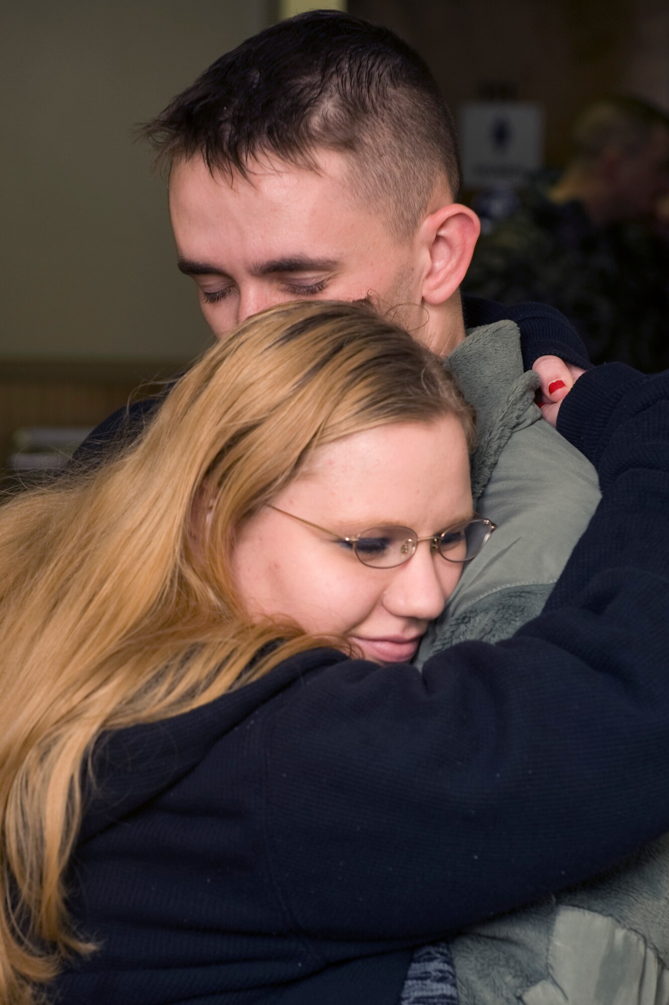 Arriving just in time for Christmas thanks to a joint effort by the 375th Air Mobility Wing and the 932nd Airlift Wing (Reserve) at Scott were 34 members of the 375th Security Forces Squadron returning from their deployment in Iraq.  Among the greeters are Mrs. Jessica Vahl who embraces her husband, Staff Sgt. Johnathan Vahl, as he arrived about 9:30 p.m. Christmas Eve.  He and the other Airmen were flown from Baltimore to Scott Air Force Base via a C-40 aircraft with both Reserve and Active-duty crewmembers volunteering to bring them home in time for the holidays.(U.S. Air Force photo/Airman 1st Class Wesley Farnsworth)