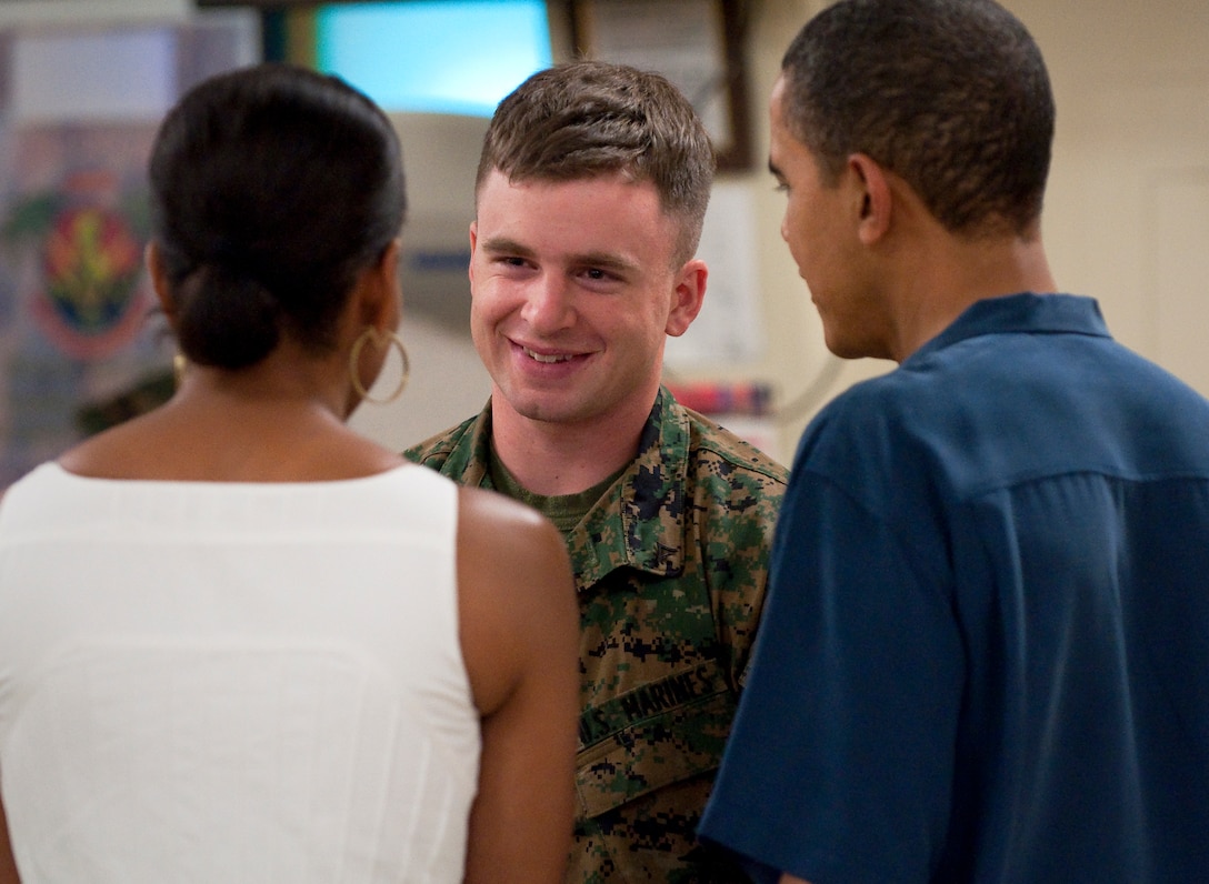 Lance Cpl. Colby W. Brown of Redmond, Ore. talks with Barack and Michelle Obama. The president and first lady surprised patrons at the award-winning Anderson Hall Dining Facility by shaking hands and talking with diners at each table during dinner Christmas Day.