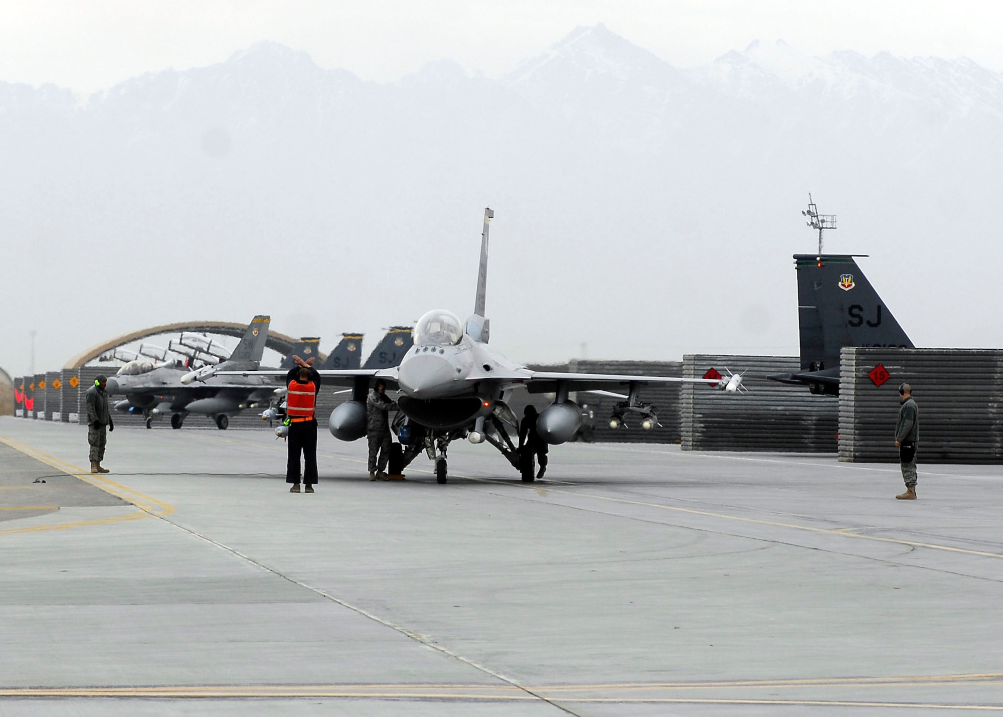 BAGRAM AIRFIELD, Afghanistan -- Airmen perform a final ammo inspection on an F-16 Fighting Falcon from the 79th Expeditionary Fighter Squadron Dec. 26, 2009. The F-16 provides a relatively low-cost, high-performance weapon system for the United States and allied nations.  (U.S. Air Force photo/Senior Airman Felicia Juenke)