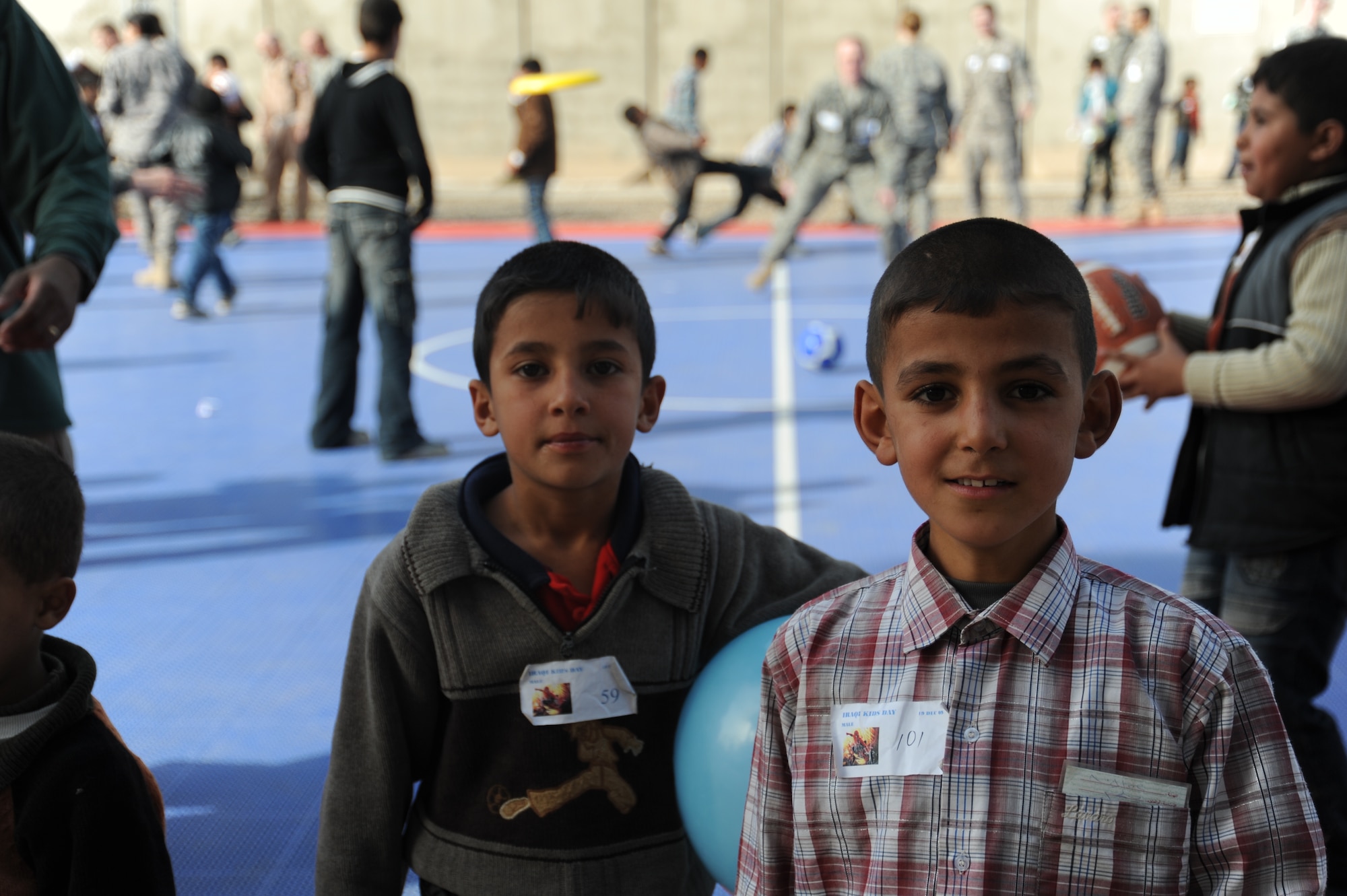 JOINT BASE BALAD, Iraq -- Two Iraqi boys pose for a photo they requested during Iraqi Kids Day at the H-6 recreation area Dec. 19, 2009. The event was part of the ongoing base effort to directly engage the local populace, bringing kids from neighboring villages together with U.S. military volunteer mentors for a day of fun, games and culture sharing. (U.S. Air Force photo/Senior Airman Christopher Hubenthal)