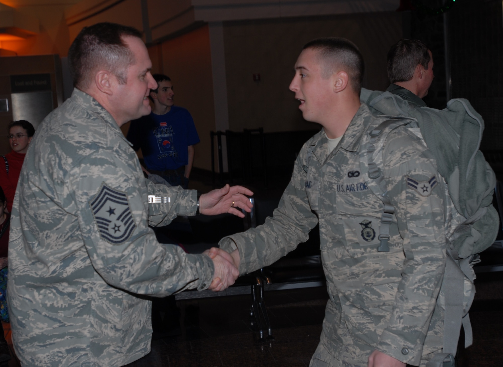 ELMENDORF AIR FORCE BASE, Alaska -- Chief Master Sgt. Tom Baker, 3rd Wing command chief, greets members of the 3rd Security Forces Squadron that returned home from a six month deployment to Iraq on Christmas Day.  (U.S. Air Force photo/Capt. Ashley Conner)
