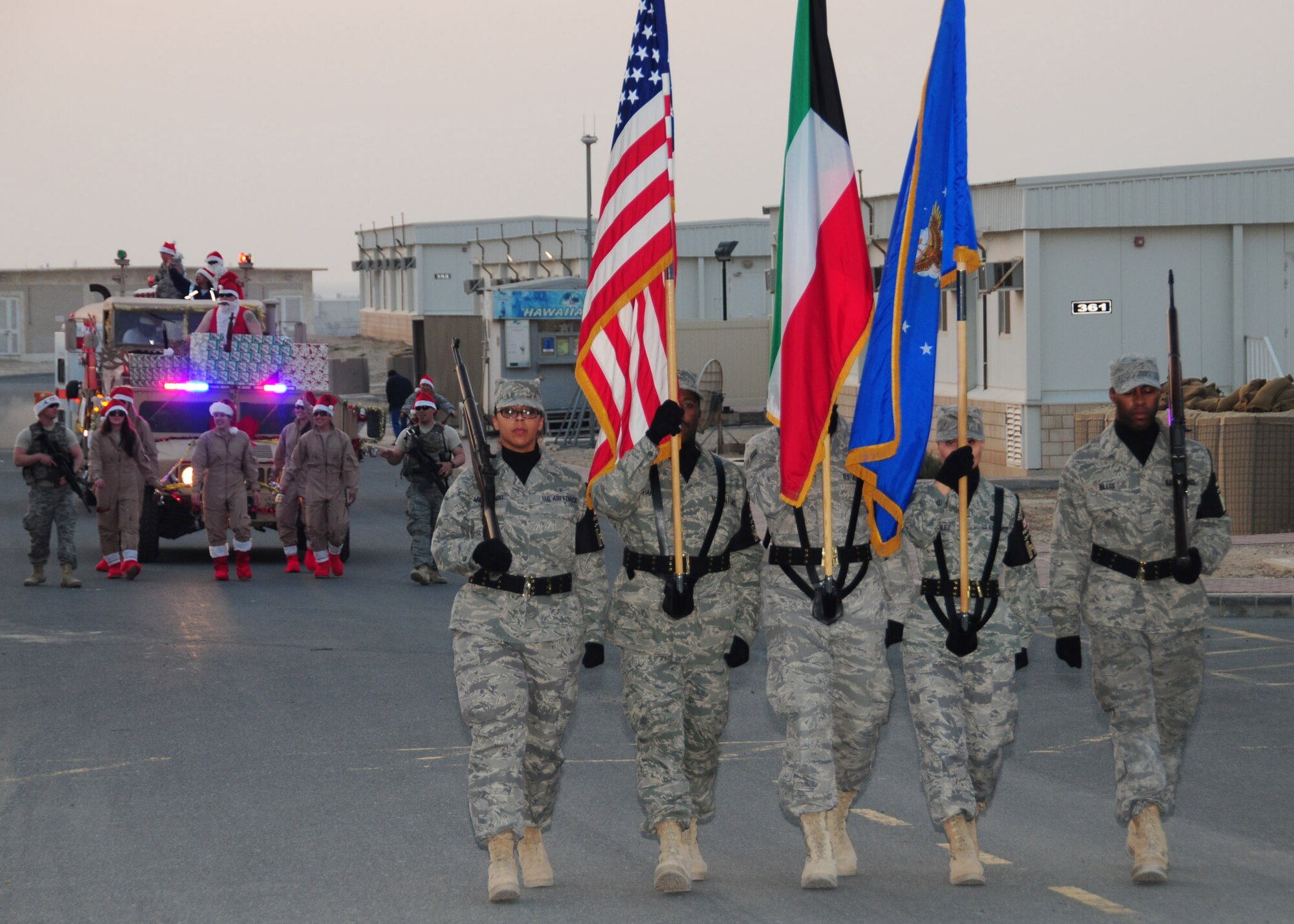 SOUTHWEST ASIA -- Members of the 386th Air Expeditionary Wing Honor Guard lead a Christmas parade through the streets of an air base in Southwest Asia Dec. 25, 2009. The 386th AEW holiday celebration included special meals at the dining facility, a parade, Christmas movie marathon and bonfire with hot chocolate and marshmallows. (U.S. Air Force photo/Tech. Sgt. Tony Tolley)