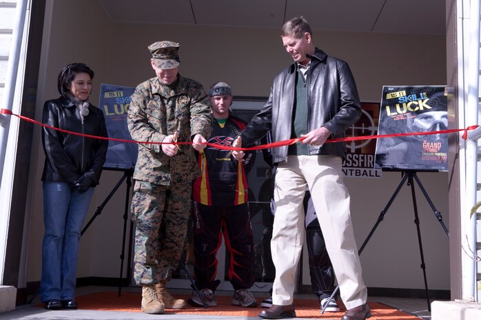 Col. Michael A. O'Halloran, Marine Corps Air Station Iwakuni commanding officer, and John Iwaniec, Marine Corps Community Services director, cut the ribbon at the grand opening of the new indoor paintball range located down the street from the Soba Shop here Dec. 26. Field hours run 5 to 10 p.m. Fridays and 11 a.m. to 7 p.m. every Saturday, Sunday and holiday. Unit and child physical training is available every Monday through Friday with reservations made at least one week in advance. The range offers paintball packages at $22 or $15 for unit physical training and $12 for children under 18 physical training. Packages include a paintball gun, mask, 200 rounds, tank rental, field fee and all day air. For those not needing everything, the range offers a la carte prices of a $10 field fee, $3 for all day air, $15 for 500 rounds and $60 for 2000 rounds.
