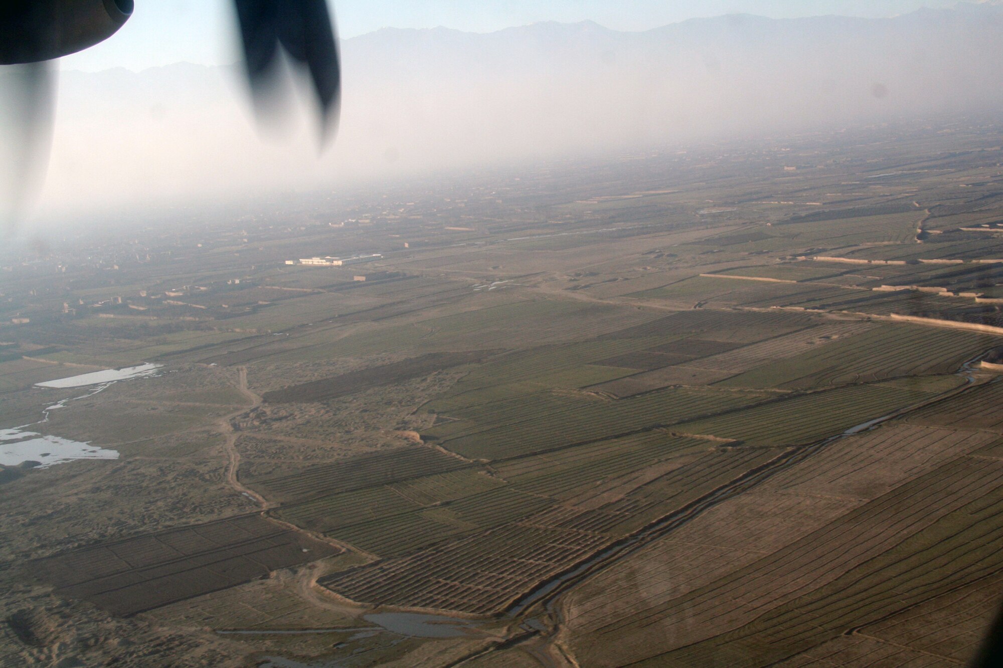 From the window of a C-130J Hercules, the terrain and a village in Afghanistan can be seen on Dec. 25, 2009. The C-130 was on an airlift mission for Operation Enduring Freedom. (U.S. Air Force Photo/Tech. Sgt. Scott T. Sturkol)