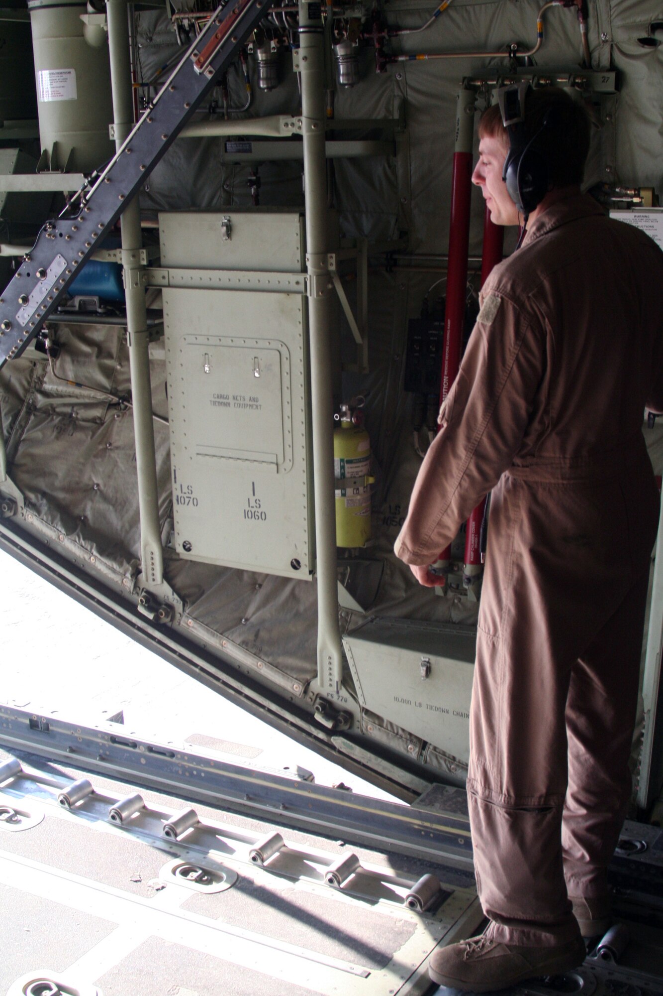 Tech. Sgt. Joe Helm, C-130J Hercules loadmaster, prepares a C-130 for an Operation Enduring Freedom mission on Dec. 25, 2009. Sergeant Helm is deployed from the 815th Airlift Squadron at Keesler Air Force Base, Miss. (U.S. Air Force Photo/Tech. Sgt. Scott T. Sturkol)