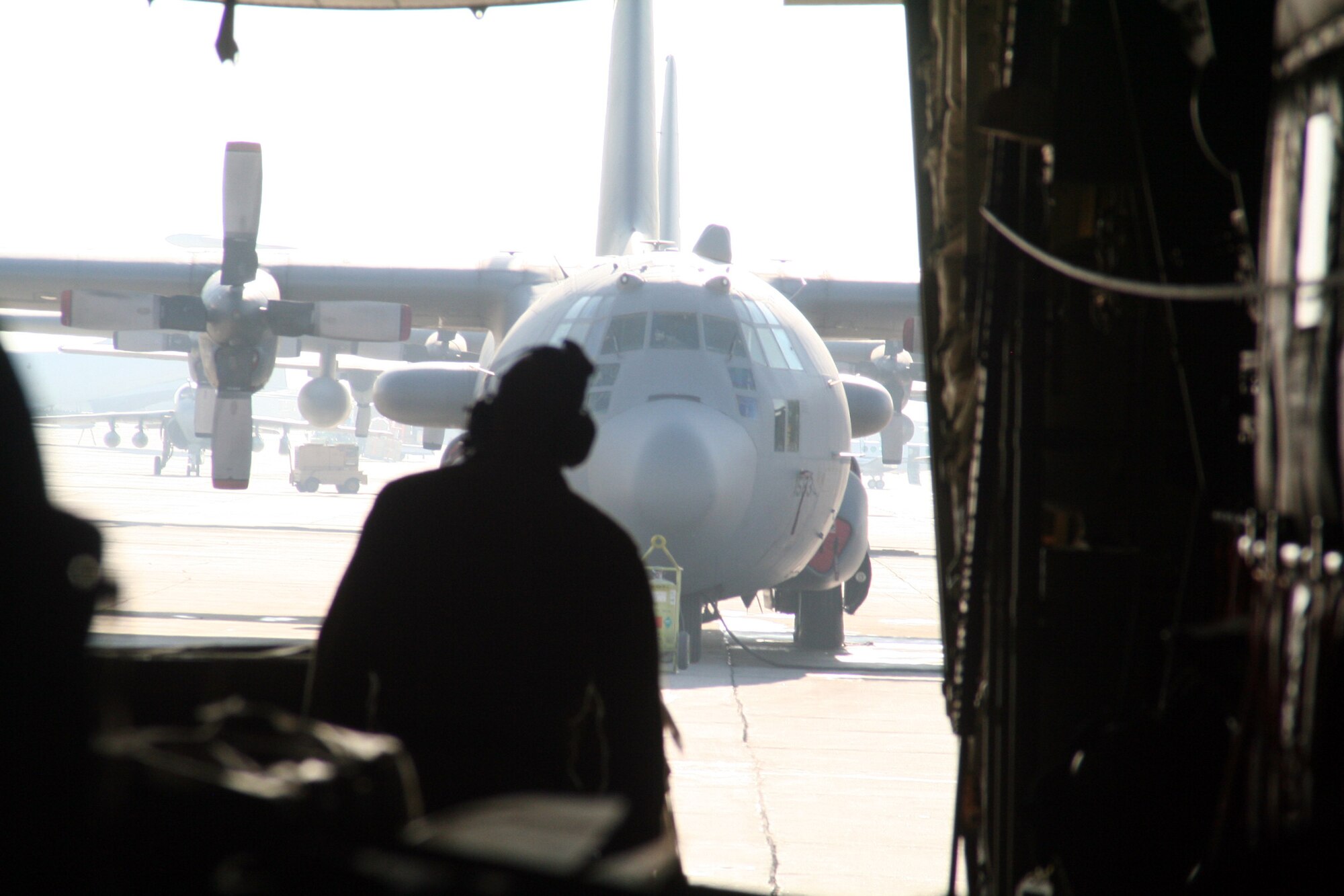 Master Sgt. John Kttrell, C-130J Hercules loadmaster, prepares the C-130J for cargo unloading during airlift operations at Bagram Air Field, Afghanistan, on Dec. 25, 2009. The C-130 was on an airlift mission for Operation Enduring Freedom. (U.S. Air Force Photo/Tech. Sgt. Scott T. Sturkol)