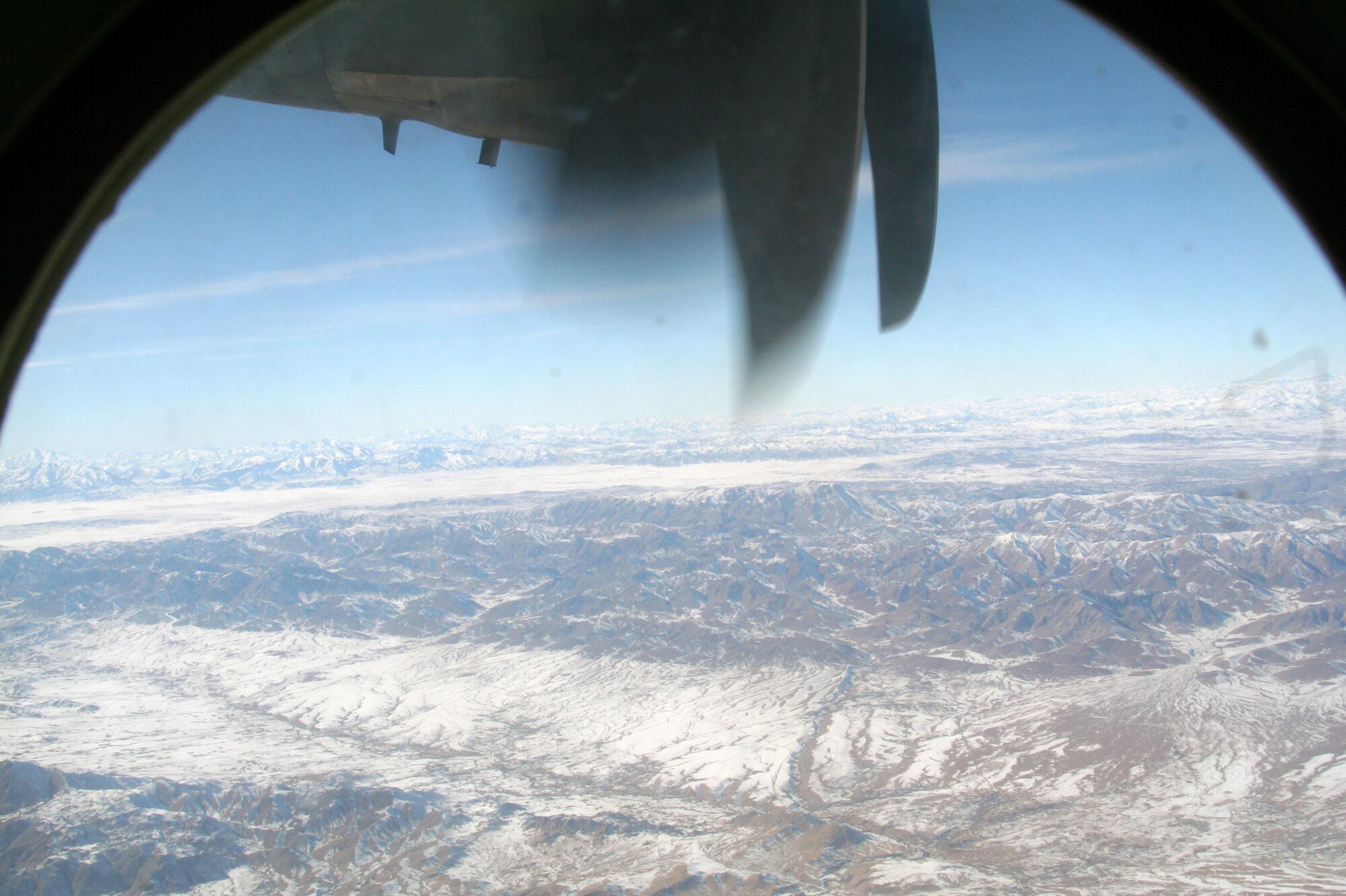 From the window of a C-130J Hercules, the mountainous terrain and a village in Afghanistan can be seen on Dec. 25, 2009. The C-130 was on an airlift mission for Operation Enduring Freedom. (U.S. Air Force Photo/Tech. Sgt. Scott T. Sturkol)