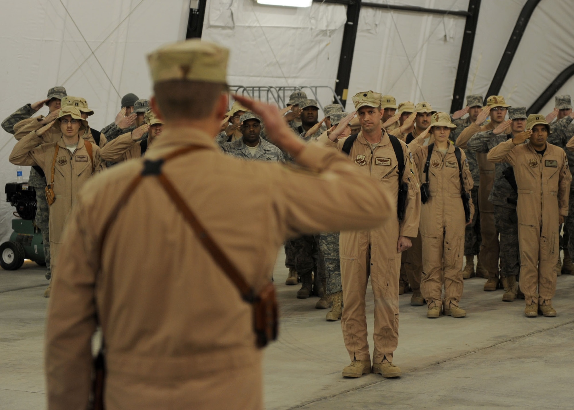 BAGRAM AIRFIELD, Afghanistan -- Lieutenant Col. Douglas Lee, Commander of the 4th Expeditionary Reconnaissance Squadron, receives his first salute from his squadron members Dec. 27, 2009.  The first Air Force MC-12 arrived today and marked the first day for the new squadron.  The MC-12's primary mission is to provide intelligence, surveillance and reconnaissance, or ISR, support directly to ground forces.  (U.S. Air Force photo/Senior Airman Felicia Juenke)