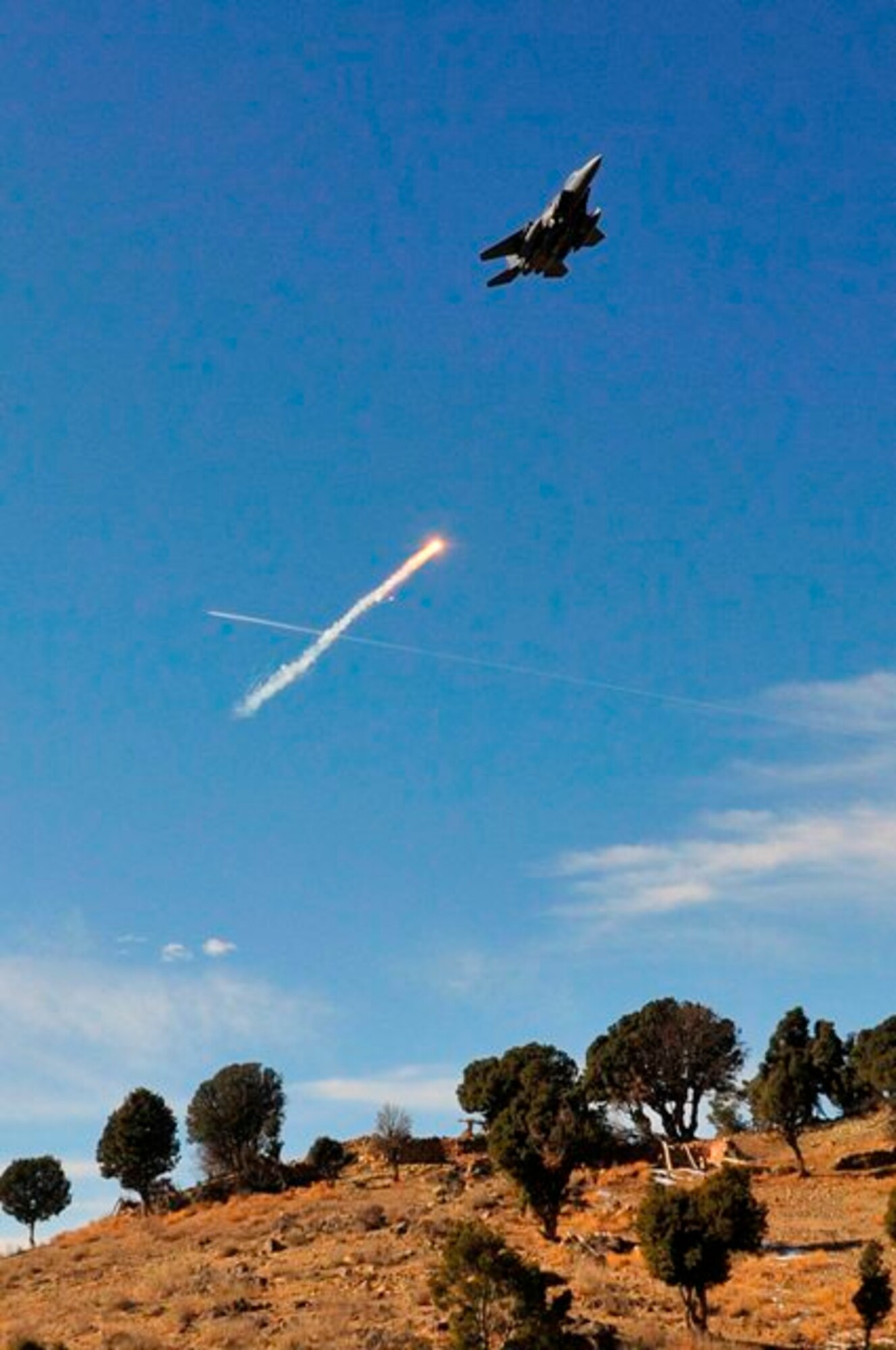 KHOST PROVINCE, Afghanistan - A U.S. Air Force F-15E Strike Eagle from the 335th Fighter Squadron at Bagram Airfield, Afghanistan, drops a flare while providing overwatch during the demolition of the “Taliban Hotel,” a safehouse utilized by insurgent fighters infiltrating Afghanistan, Dec. 18. An Explosive Ordnance Disposal team from the 707th EOD unit, out of Fort Lewis, Wash., partnered with Soldiers from the soldiers from the 1st Squadron, 40th Cavalry Regiment, 4th Brigade Combat Team, 25th Infantry Division, out of Fort Richardson, Alaska,, and Afghan National Security Forces to explosively level the safehouse. (U.S. Air Force photo/Staff Sgt. Stephen J. Otero)
