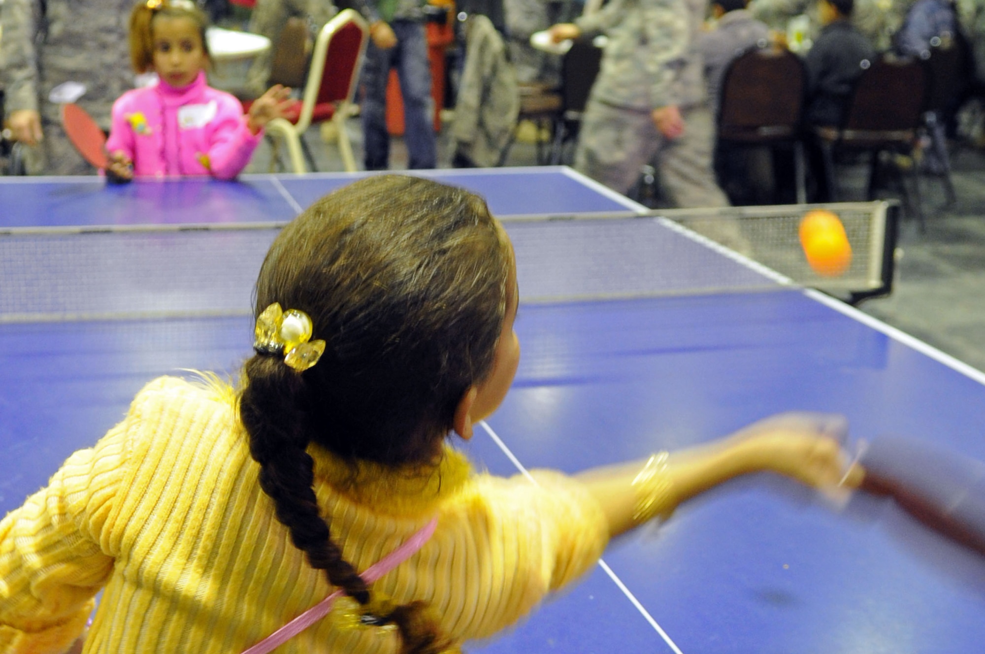JOINT BASE BALAD, Iraq -- Two Iraqi girls play ping pong at the H-6 recreation area Dec. 19, 2009, during Iraqi Kids Day. More than 200 local children and their assigned U.S. military volunteer mentors also played darts, billiards, board games, foosball, basketball and soccer. (U.S. Air Force photo/Airman 1st Class Brittany Y. Bateman)
