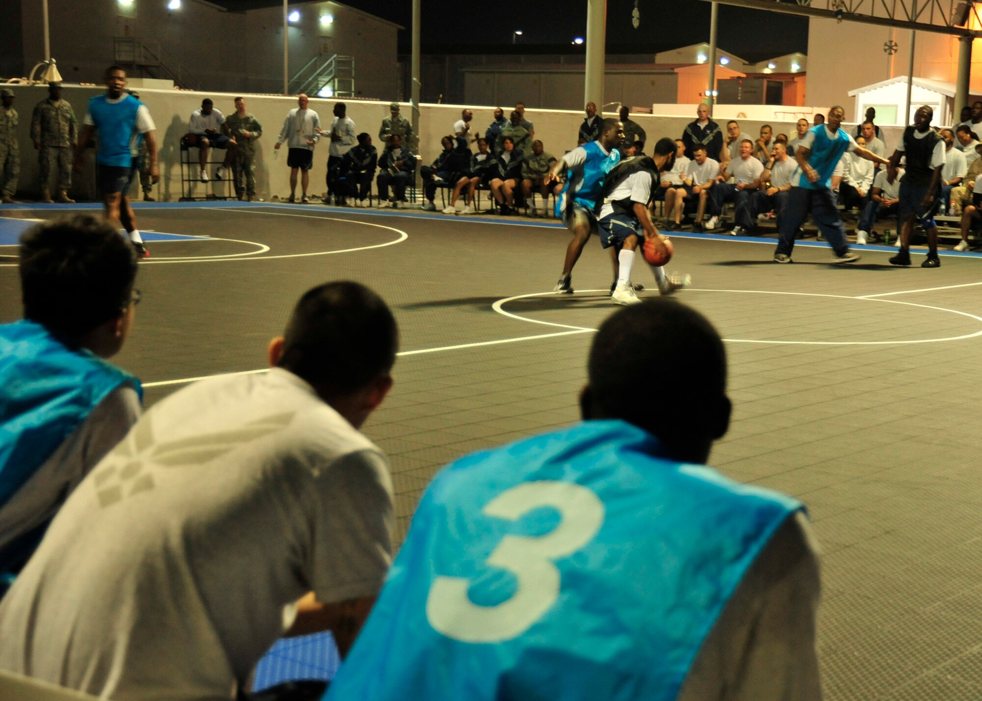 The 380th Expeditionary Security Forces Squadron force protection team defends against the 380th Expeditionary Force Support Squadron during the 380th Expeditionary Force Support Squadron morale basketball tournament at an undisclosed location in Southwest Asia on Dec. 26, 2009. The basketball tournament is ongoing and will end at the end of January. (U.S. Air Force Photo/Senior Airman Jenifer H. Calhoun) 