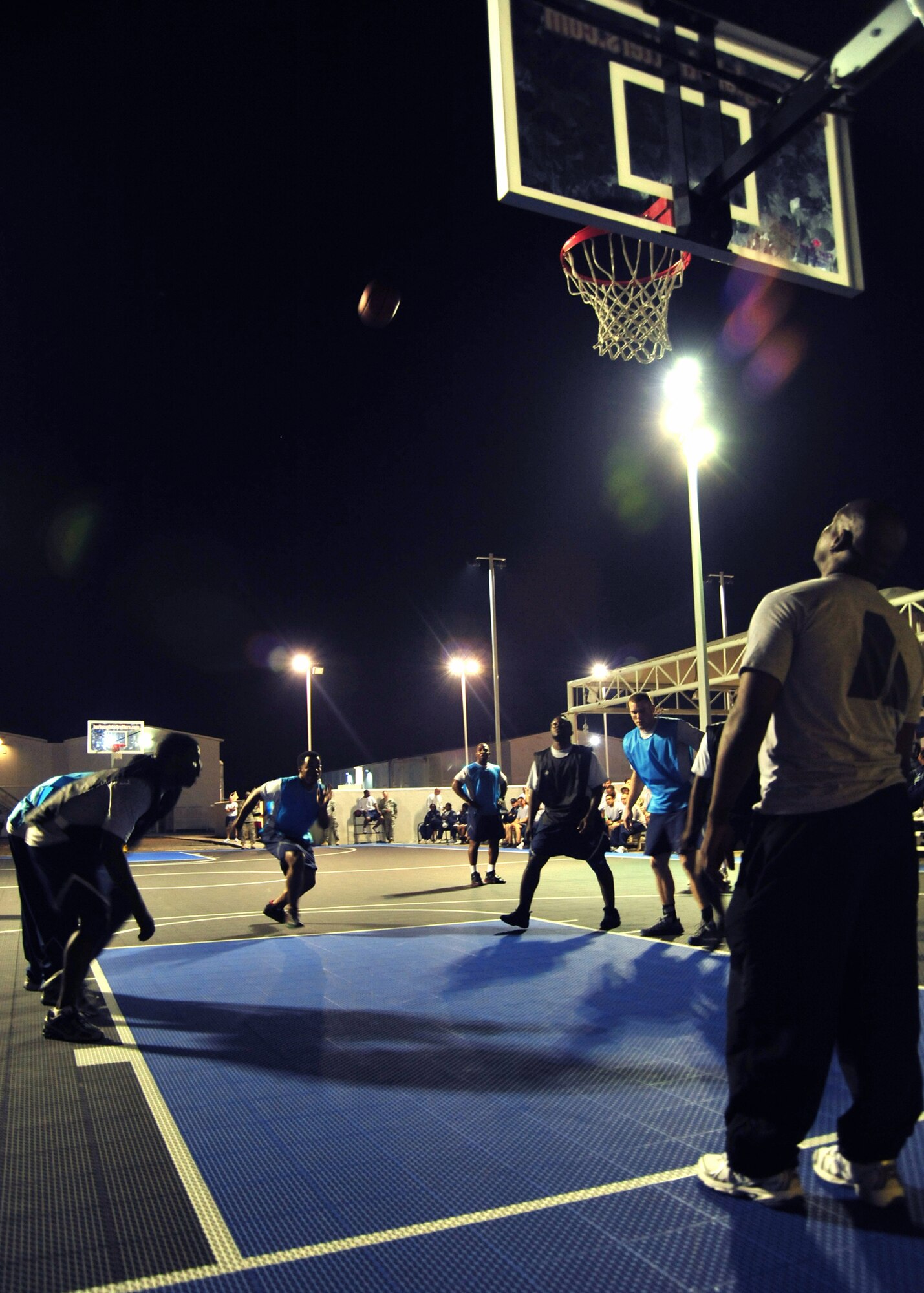 Referee U.S. Army Sgt. 1st Class Samueal Hill watches as a penalty shot is made by the 380th Expeditionary Security Forces Squadron force protection team against the 308th Expeditionary Force Support Squadron team during the 380th Expeditionary Force Support Squadron morale basketball tournament at an undisclosed location in Southwest Asia on Dec. 26, 2009. Force support sponsored the basketball tournament to increase moral within the base. (U.S. Air Force Photo/Senior Airman Jenifer H. Calhoun)