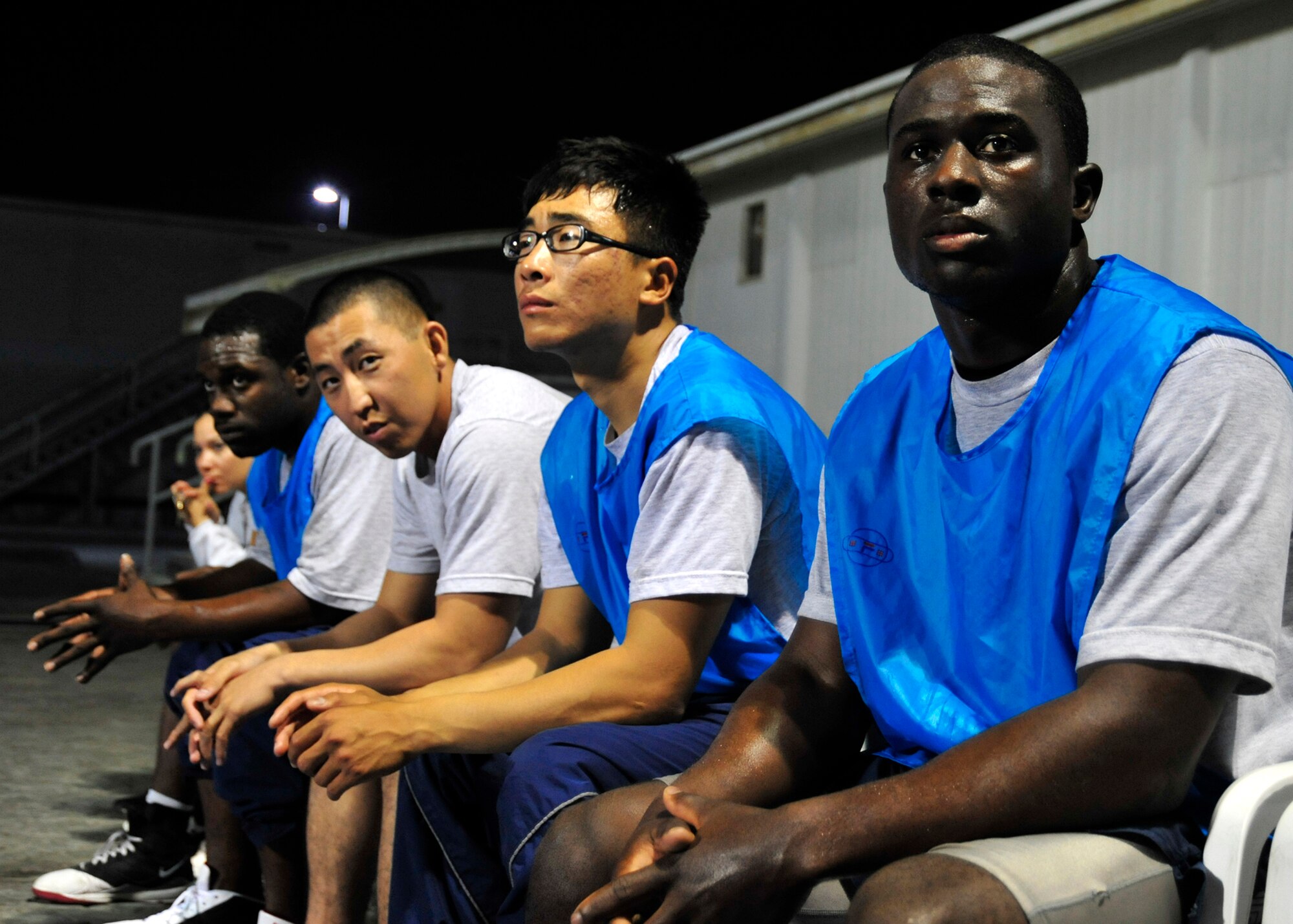 Members of the 380th Expeditionary Security Forces Squadron force protection team look on as members of their team play against the 308th Expeditionary Force Support Squadron team during the 380th Expeditionary Force Support Squadron morale basketball tournament at an undisclosed location in Southwest Asia on Dec. 26, 2009. Force protection won the game 31 to 26 against the force support squadron. (U.S. Air Force Photo/Senior Airman Jenifer H. Calhoun)  