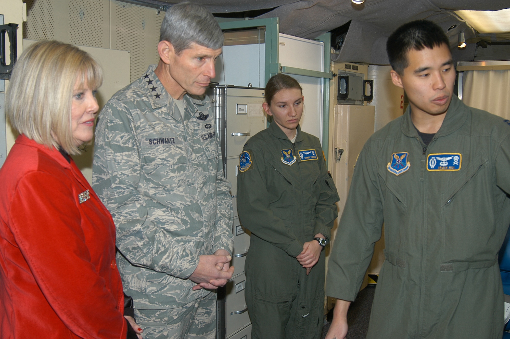 Capt. Irwin Hui (right) and 1st Lt. Sydney Todorov, missile combat crewmembers with the 320th Missile Squadron at F.E. Warren Air Force Base, Wyo., brief Air Force Chief of Staff Gen. Norton Schwartz and Mrs. Schwartz Dec. 25, 2009, inside the launch control center of a missile alert facility.  The general and Mrs. Schwartz visited the base during Christmas to thank Airmen in 24-hour work centers and to reinforce the Air Force's commitment to the nuclear enterprise.  (U.S. Air Force photo/Capt. Mary Danner)