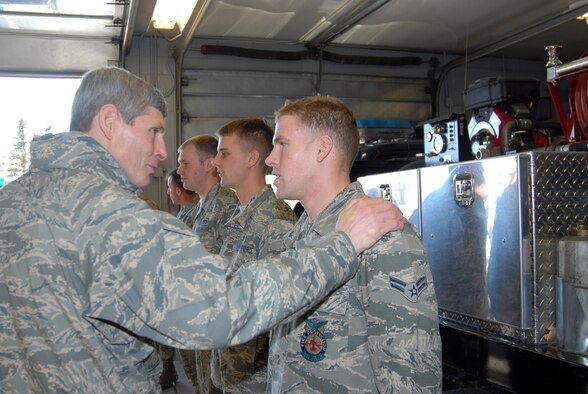 Air Force Chief of Staff Gen. Norton Schwartz thanks Airman 1st Class Kory Lindbom, a firefighter at F.E. Warren Air Force Base, Wyo., Dec. 24, 2009, for being an important part of the Air Force team and the 90th Missile Wing mission. The general and Mrs. Schwartz visited the base during Christmas to thank Airmen in 24-hour work centers and to reinforce the Air Force's commitment to the nuclear enterprise.  (U.S. Air Force photo/Berni Ernst)