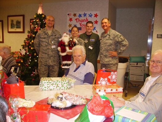 Senior Master Sgt. Tom Lehman, Tech Sgt. Denise Hauser, Staff Sgt. Gary Taiclet, and Senior Airman Doug Evans attend the Christmas Eve Holiday party at the Baldomero Lopez State Veterans' Nursing Home. (U.S. Air Force photo) 