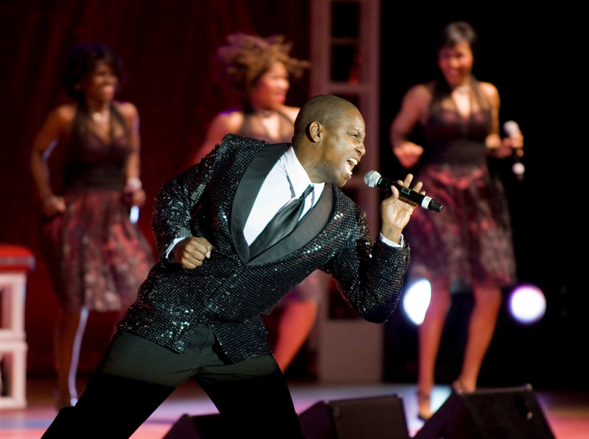 MISAWA CITY, Japan -- Tech. Sgt. Octavious Hill, Tops in Blue vocalist, sings a solo during the Tops in Blue performance at the Misawa Civic Center Dec. 27, 2009. Tops in Blue performed for an audience of American and Japanese community members. Sergeant Hill is a heating, ventilation, air conditioning and refrigeration craftsman for the 99th Civil Engineer Squadron, Nellis Air Force Base, Nev. (U.S. Air Force photo/Staff Sgt. Samuel Morse)