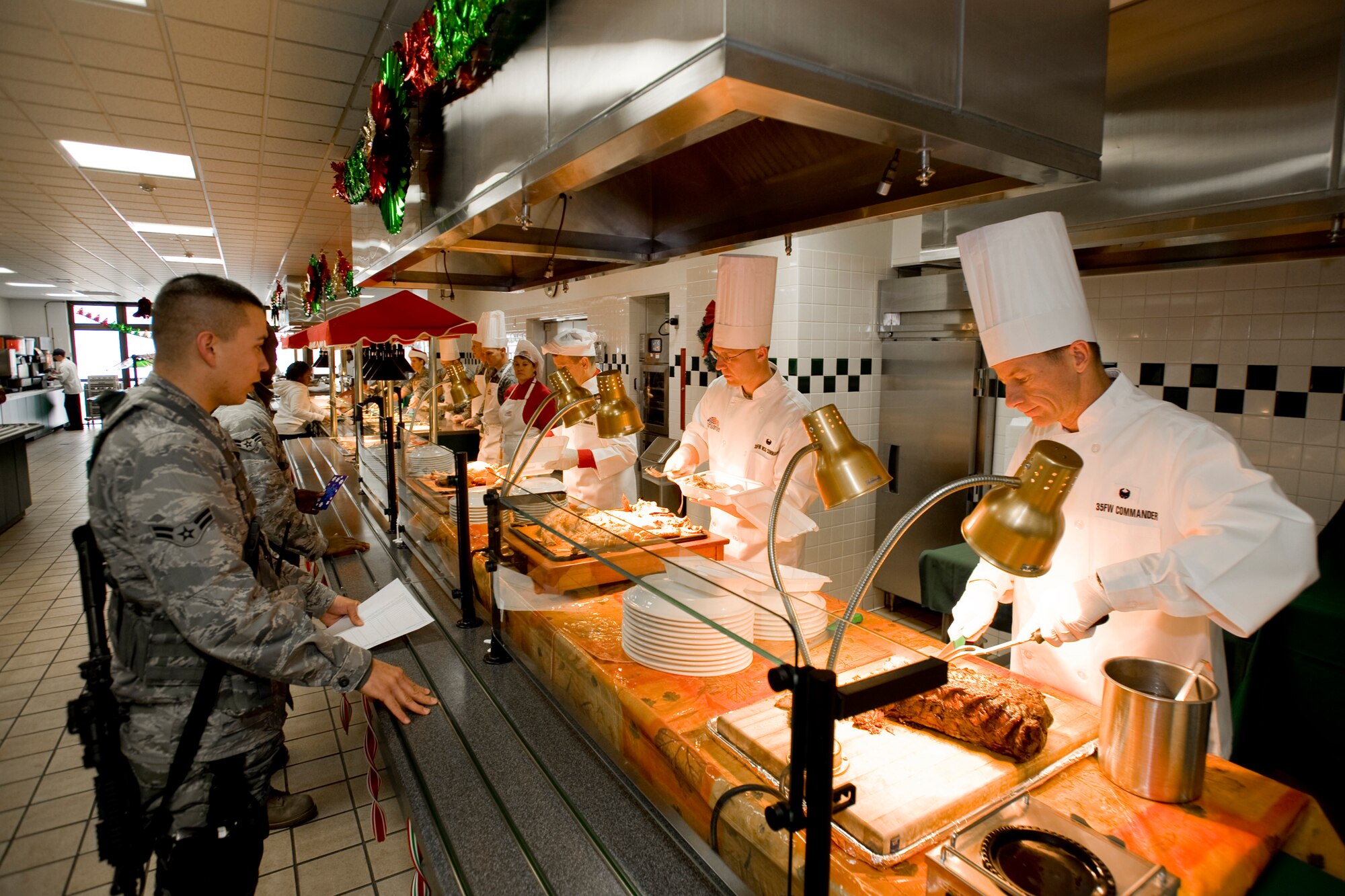 MISAWA AIR BASE, Japan -- Col. David Stilwell, 35th Fighter Wing commander, and other leaders from Misawa serve holiday meals at the Grissom Dinning Facility on Christmas day. Unaccompanied service members and families came out to take part in the meal. (U.S. Air Force photo/Senior Airman Jamal D. Sutter)