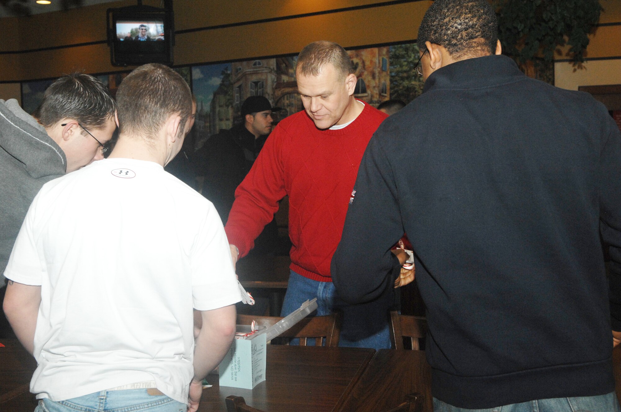 Chief Master Sgt. of the Air Force James Roy hands out candy canes and meets with Airmen of the 5th Bomb Wing and 91st Missile Wing Dec. 24, 2009, during a holiday social for dorm residents at the base community center at Minot Air Force Base, N.D. Chief Roy spent part of the Christmas weekend at Minot to meet Airmen and tell them their work in the nuclear enterprise is critical and that Air Force leaders are committed to their development. (U.S. Air Force photo/Senior Airman Jesse Lopez)
