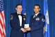 McGHEE TYSON AIR NATIONAL GUARD BASE, Tenn. -- Tech. Sgt. Dallas E. Perry, right, an aircraft fuel systems craftsman with the 175th Wing, Maryland Air National Guard, receives the distinguished graduate award for Satellite NCO Academy Class 10-2 at The I.G. Brown Air National Guard Training and Education Center here from retired Chief Master Sgt. Lynn E. Alexander, the second senior enlisted advisor of the Air National Guard, Dec. 15, 2009.   The distinguished graduate award is presented to students in the top ten percent of the class.  It is based on objective and performance evaluations, demonstrated leadership, and performance as a team player. (U.S. Air Force photo by Master Sgt. Kurt Skoglund/Released)