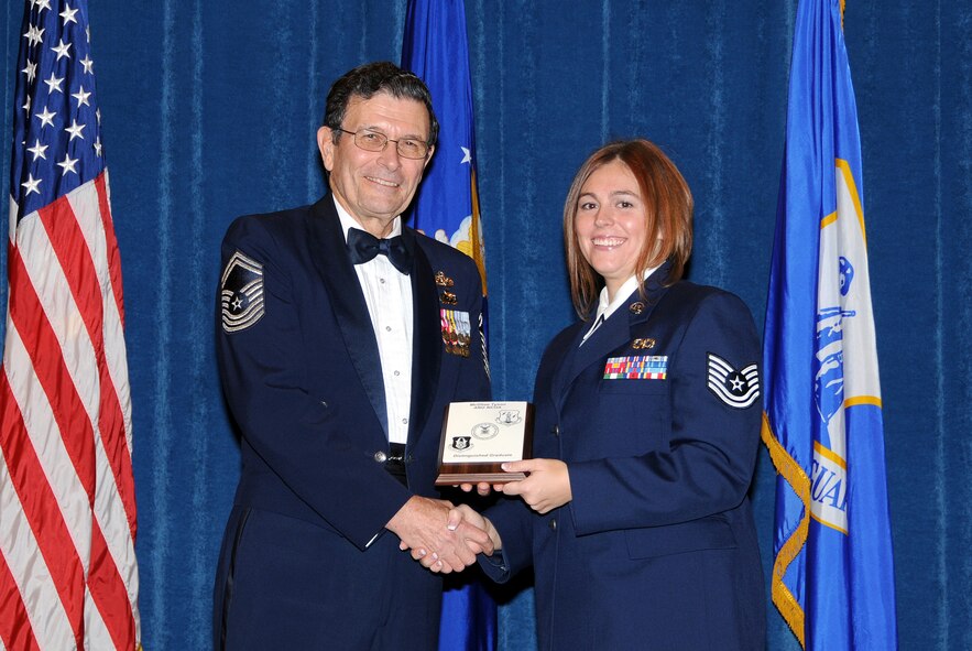 McGHEE TYSON AIR NATIONAL GUARD BASE, Tenn. -- Tech. Sgt. Nicole R. Wagoner, right, a safety apprentice with the 179th Airlift Wing, Ohio Air National Guard, receives the distinguished graduate award for Satellite NCO Academy Class 10-2 at The I.G. Brown Air National Guard Training and Education Center here from retired Chief Master Sgt. Lynn E. Alexander, the second senior enlisted advisor of the Air National Guard, Dec. 15, 2009.   The distinguished graduate award is presented to students in the top ten percent of the class.  It is based on objective and performance evaluations, demonstrated leadership, and performance as a team player.   (U.S. Air Force photo by Master Sgt. Kurt Skoglund/Released)