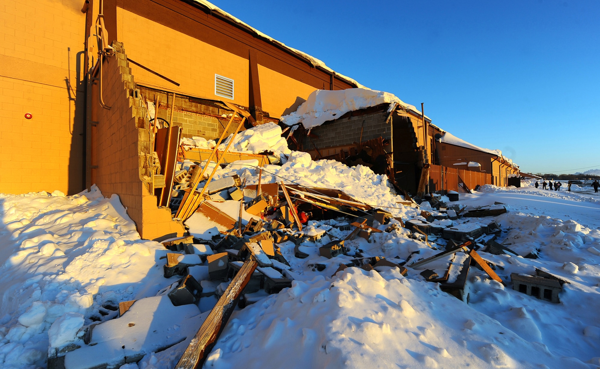 OFFUTT AIR FORCE BASE, Neb. - Accumulated snow collapses a small outbuilding on the eastern side of the Offutt Field House Dec. 26.  The base experienced two large snow storms in recent weeks which produced several feet of snow. U.S. Air Force photo by Josh Plueger
