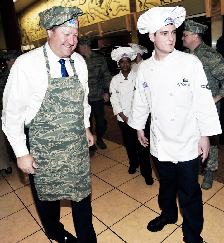 Secretary of the Air Force Michael B. Donley and Airman Casey Hutcheson prepare to serve Christmas Day dinner at the Gingko Tree Dining Facility at Osan Air Base, South Korea, Dec. 25, 2009. Secretary Donley met with Airmen assigned to the 51st Fighter Wing, 8th Fighter Wing, 7th Air Force and South Korean airmen during his two-day trip to the peninsula. Airman Hutcheson is assigned to the 51st Force Support Squadron at Osan AB.(U.S. Air Force photo/1st Lt. Chris Hoyler)