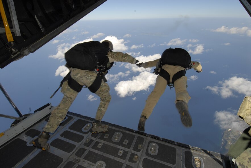 Lieutenant Colonel Stephen Goodman and Capt. Robert Wilson, 31st Rescue Squadron, perform a high altitude low opening jump over Ie Shima Island, Japan Dec. 23, 2009. The jump was part of routine training for the 31st and the 320th Special Tactics Squadron. (U.S. Air Force photo / Airman 1st Class Chad Warren)