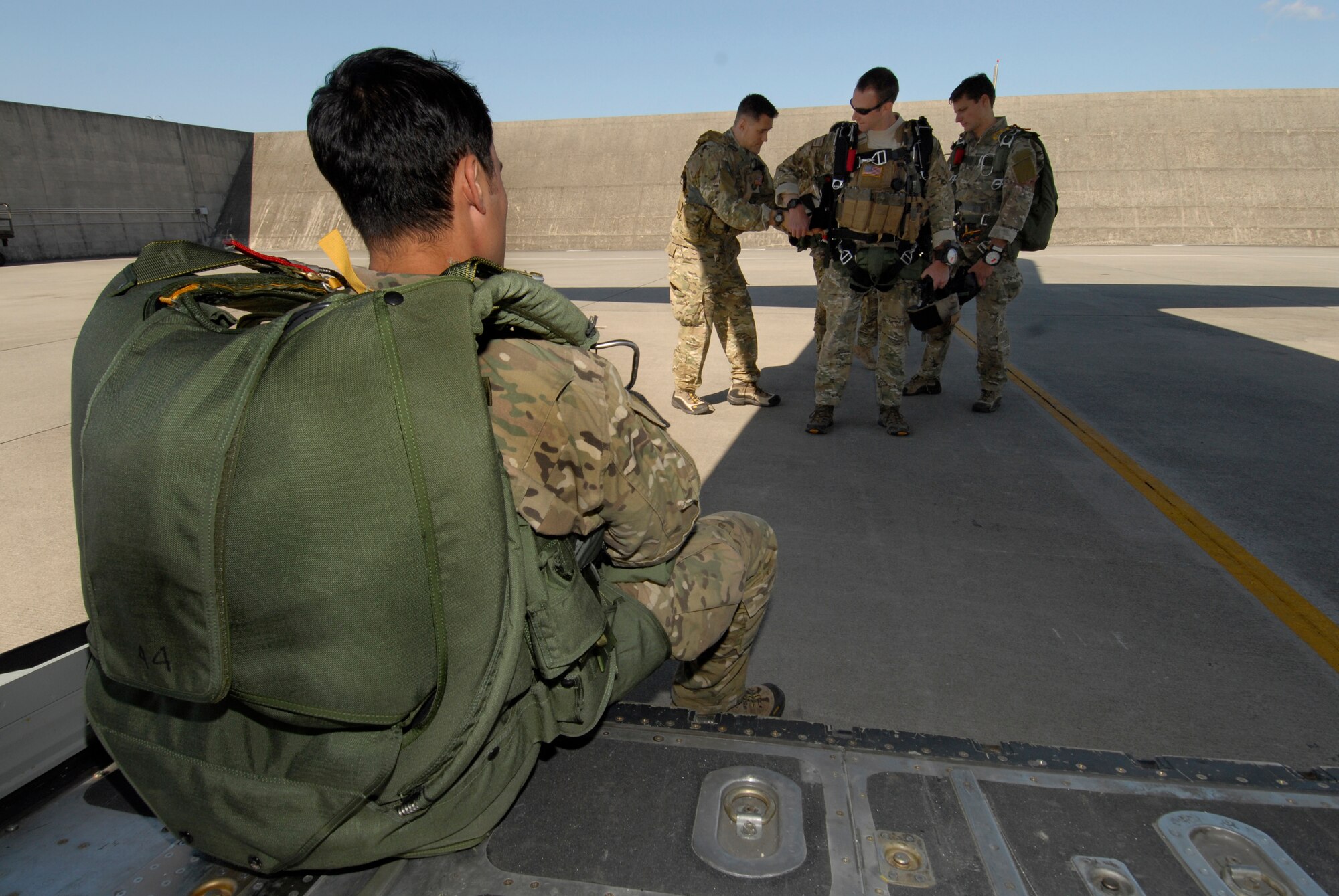 Pararescuemen assigned to Kadena Air Base, Japan prepare for a high altitude low opening jump over Ie Shima Island, Japan Dec. 23, 2009. The jump was part of routine training for the 320th Special Tactics Squadron and the 31st Rescue Squadron. (U.S. Air Force photo / Airman 1st Class Chad Warren)
