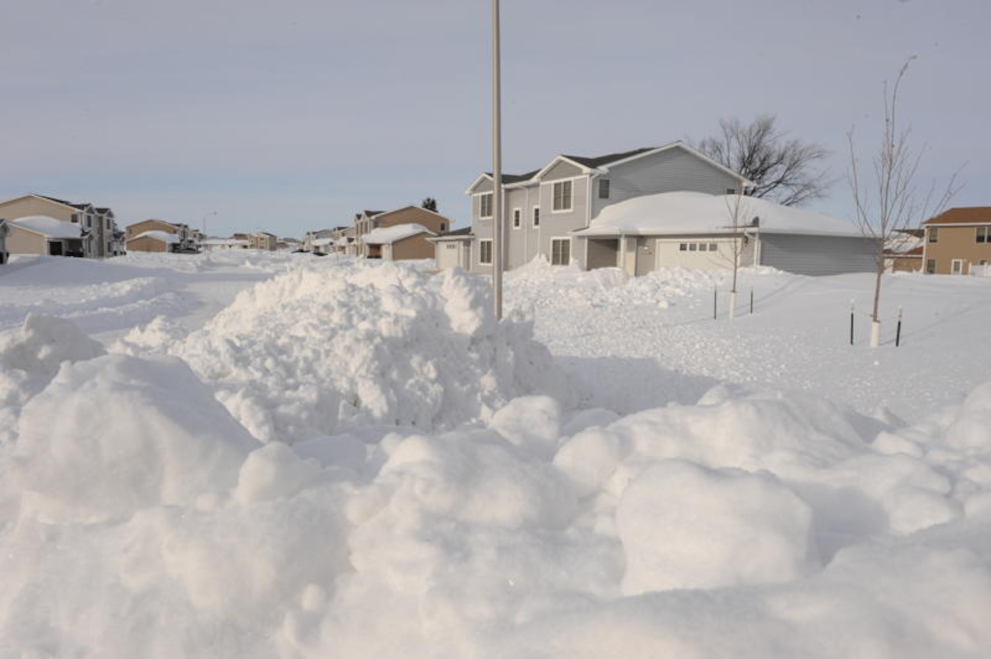 MINOT AIR FORCE BASE, N.D. -- Snow piled up in front of housing after Minot residents recover from blizzard here, Dec. 29. A christmas weekend blizzard resulted in 25.7 inches of snow. In addition to this, the drifts made driving difficult on surrounding highways and in the surrounding communities. (U.S. Air Force Photo by Staff Sgt. Stacy Moless)
