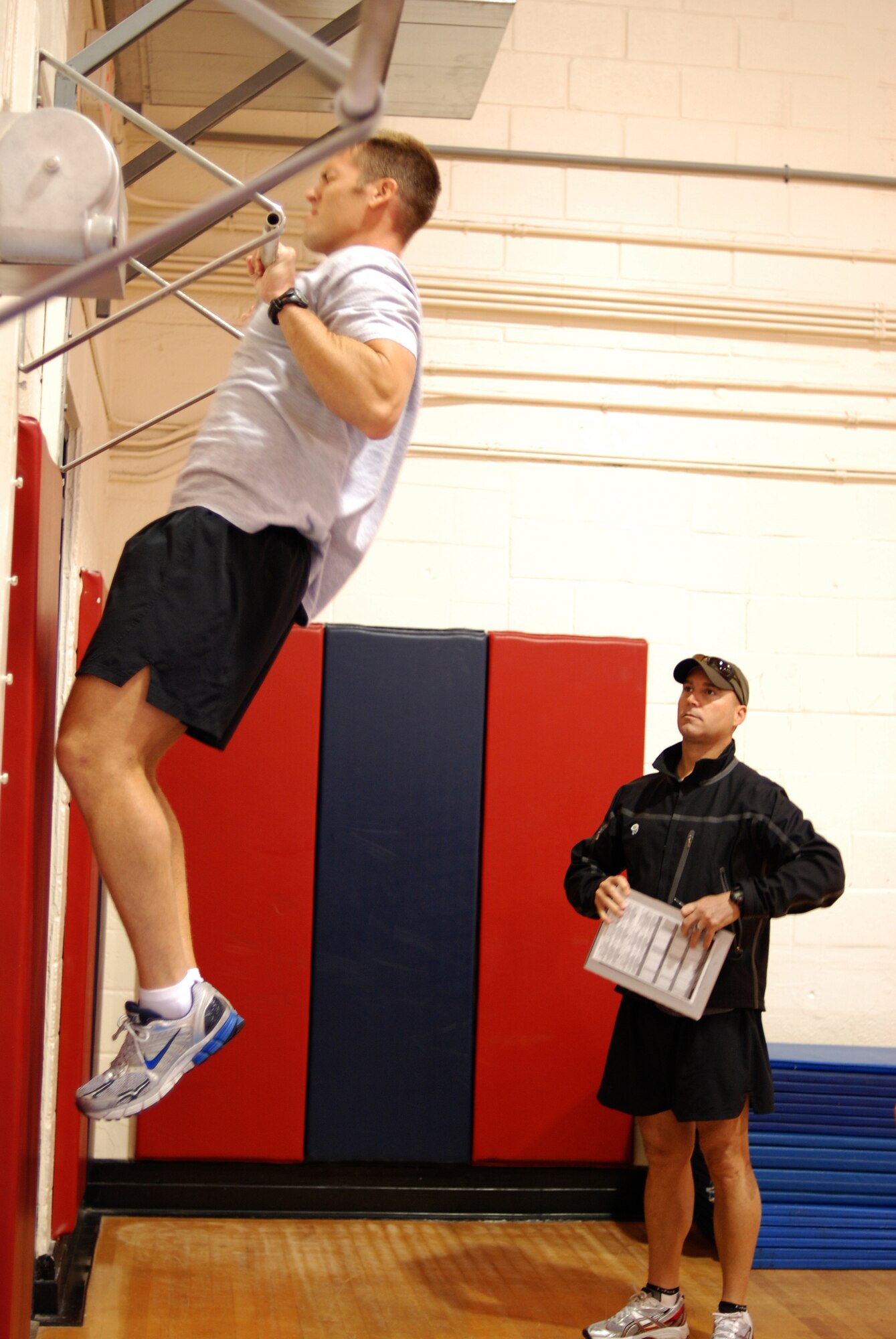 PATRICK AIR FORCE BASE, Fla. - Capt. Dan Turpin is timed on his chin-ups during the P.A.S.T testing given by Tech. Sgt. Patrick Dunne, Air Force Reserve Pararescueman.Turpin is scheduled for INDOC training the beginning of January. (U.S. Air Force Photo/Staff Sgt. Leslie Kraushaar)